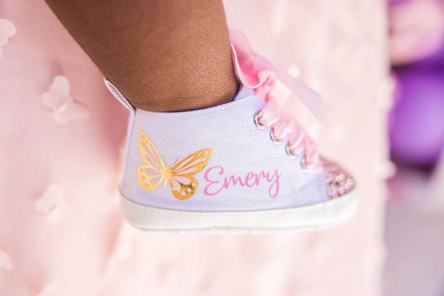 Custom lavender high-top sneaker with gold butterfly and name Emery for birthday.