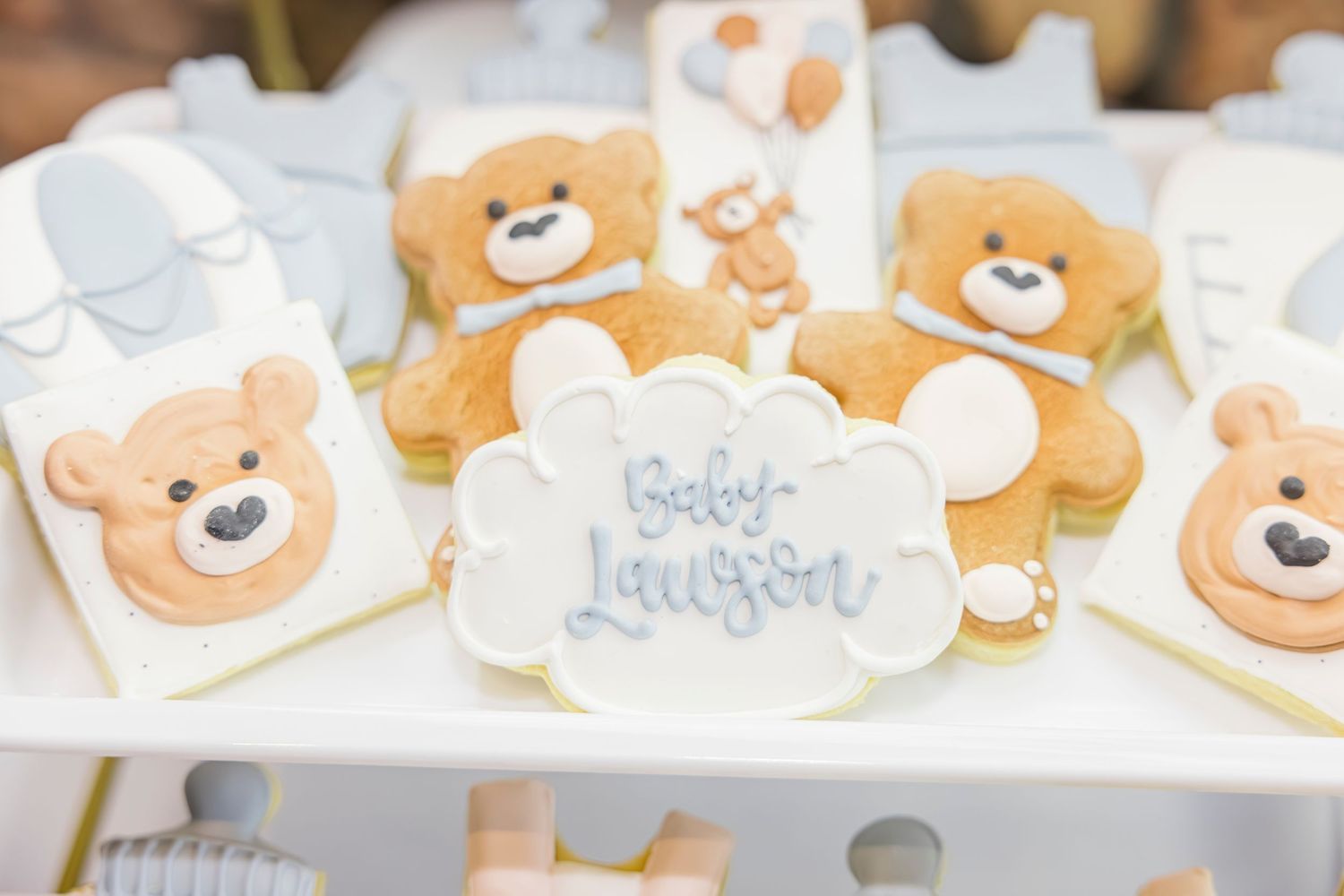 Teddy bear shaped sugar cookies with royal icing decoration for Baby Lawson baby shower.
