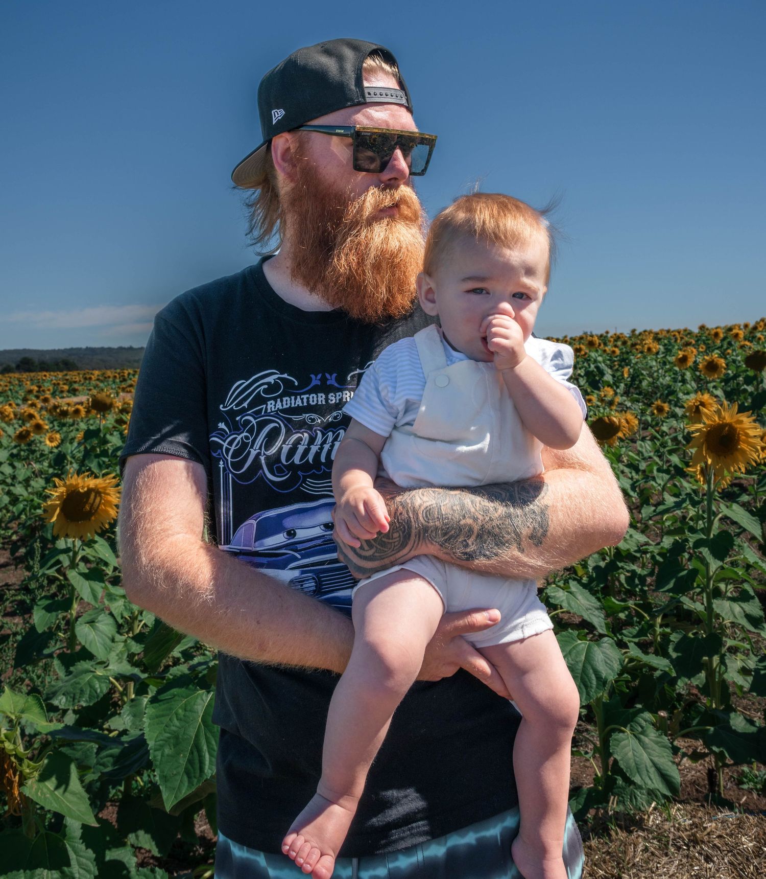 Candid family interaction in a sunflower field in regional Victoria