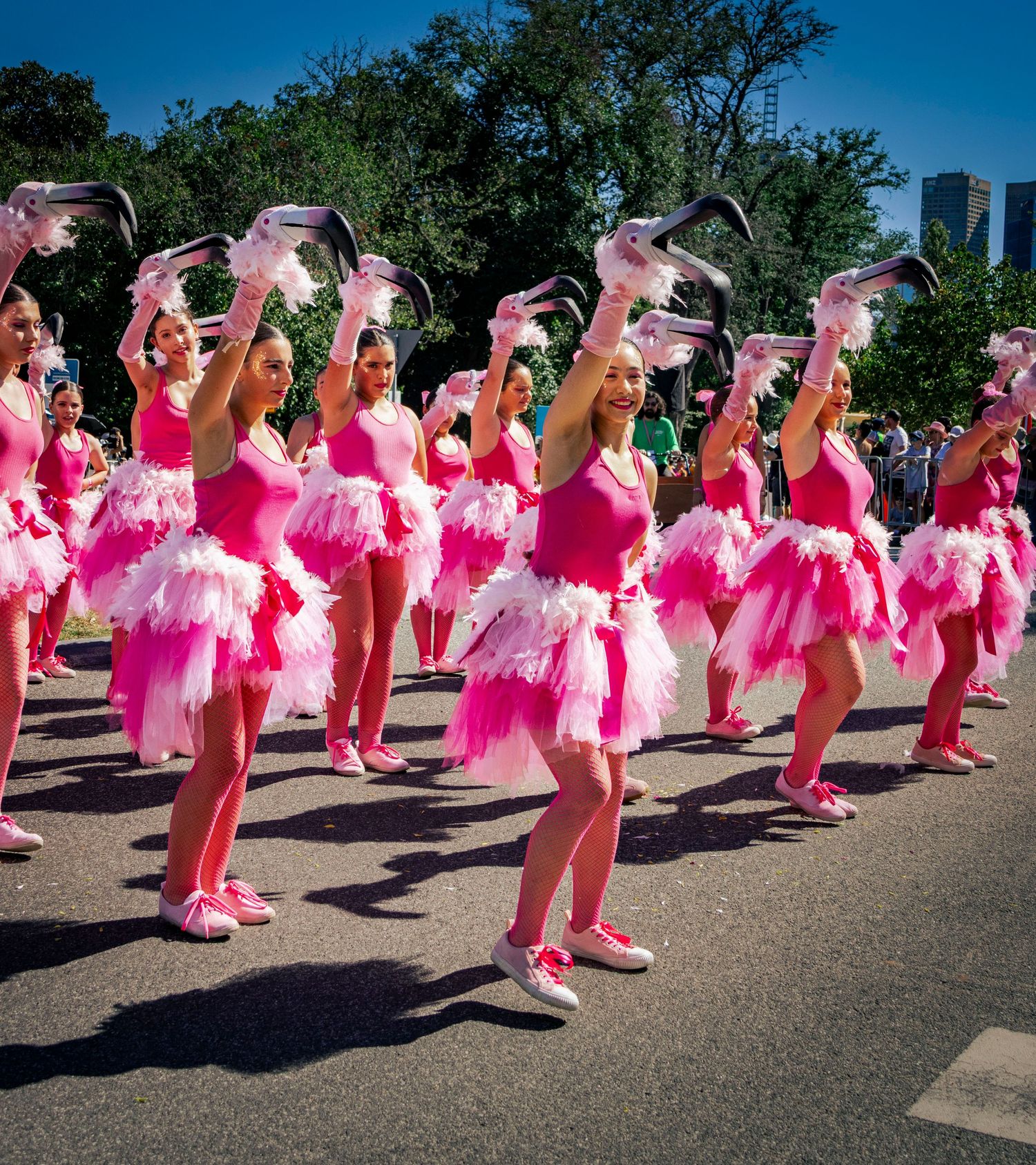 Dance group performing in pink costumes at Moomba parade Melbourne