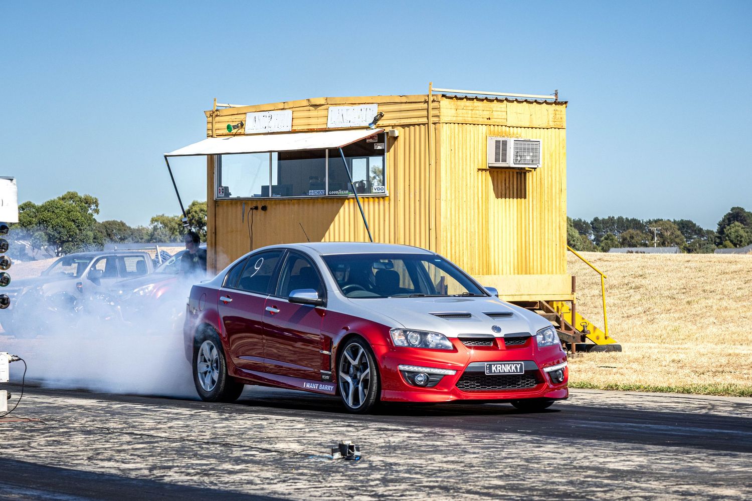 Drag racing action with red car and smoke at Ballarat raceway Victoria
