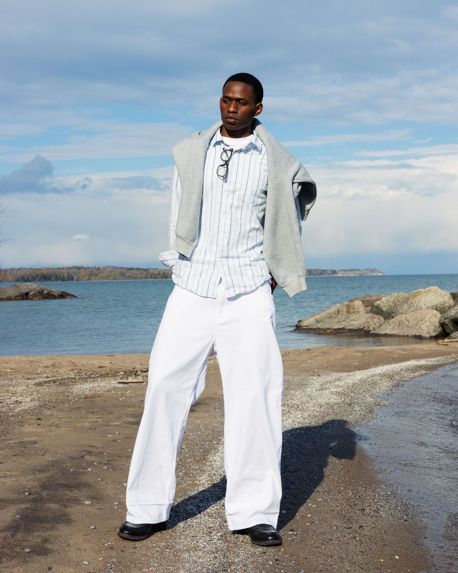 Outdoor portrait of male model standing near beach in Oshawa.