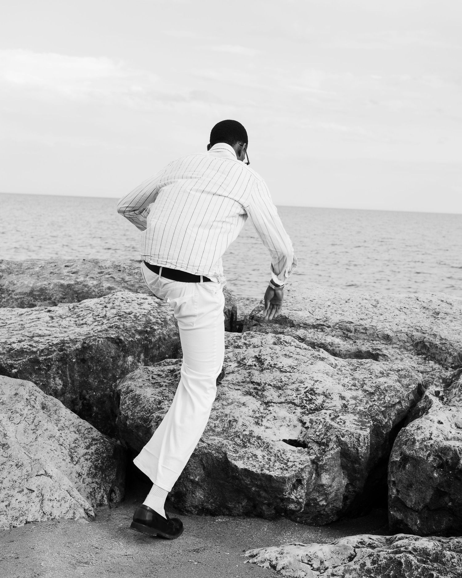 Outdoor portrait of male model standing near beach in Oshawa.
