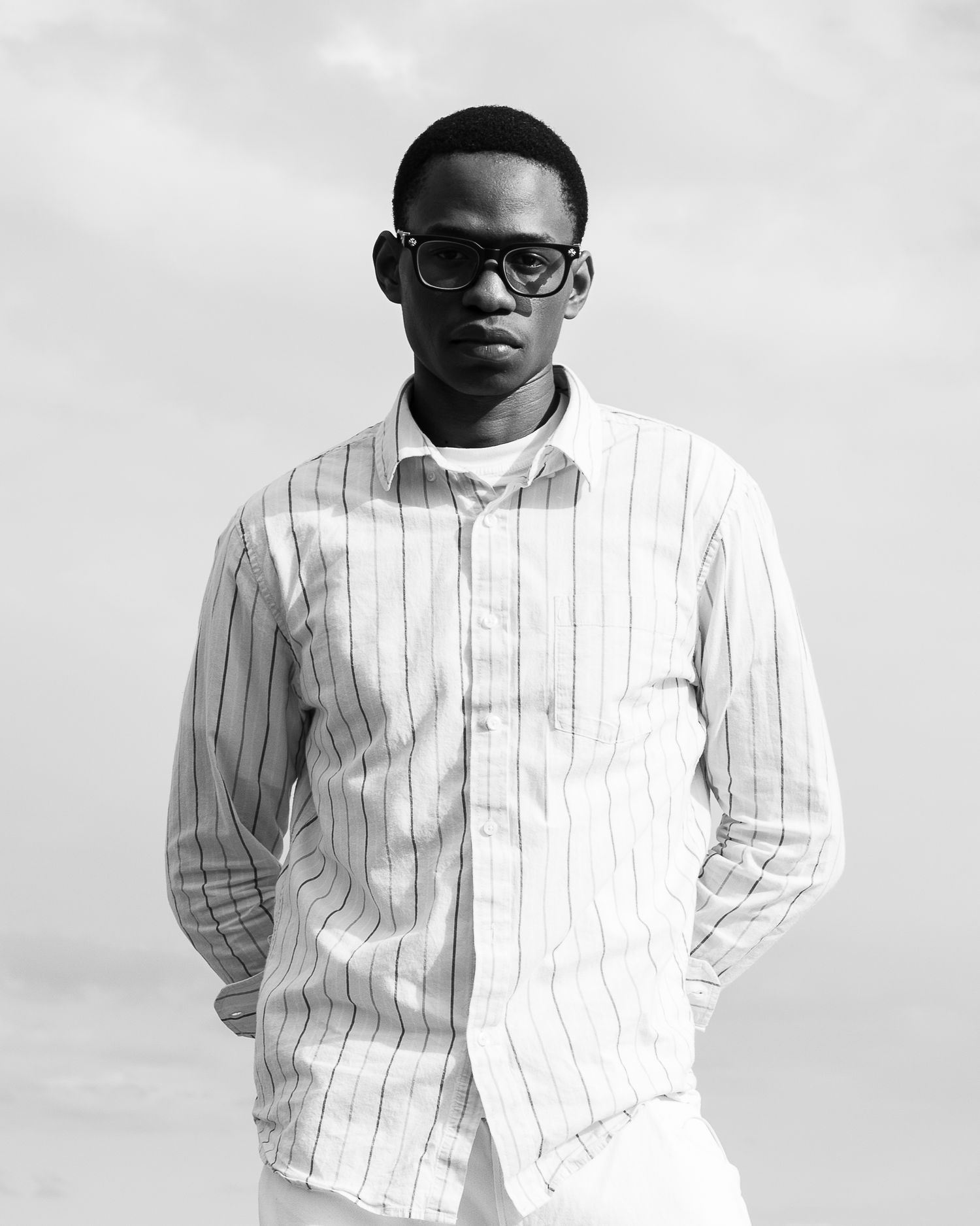 Outdoor portrait of male model standing near beach in Oshawa.