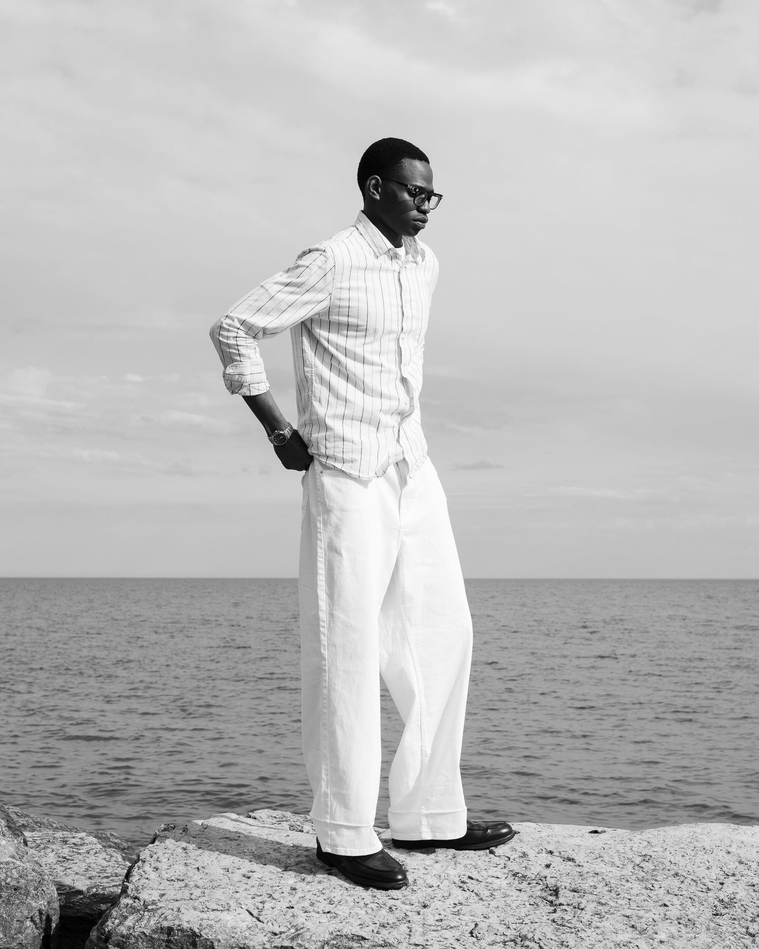 B/W Outdoor portrait of male model standing near beach in Oshawa.