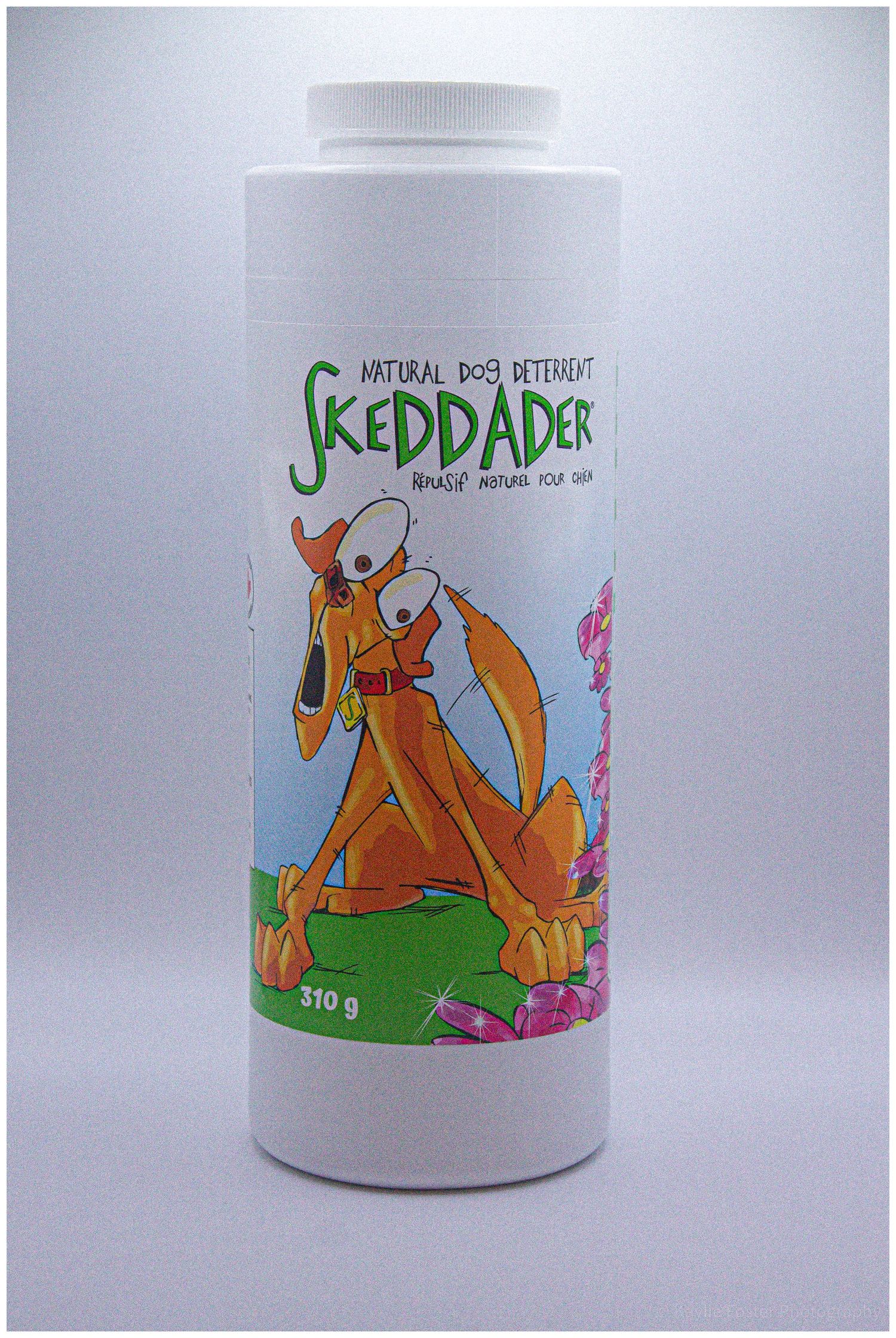 Skeddader Natural Dog Deterrent powder 310g container featuring a cartoon dog illustration on white bottle.