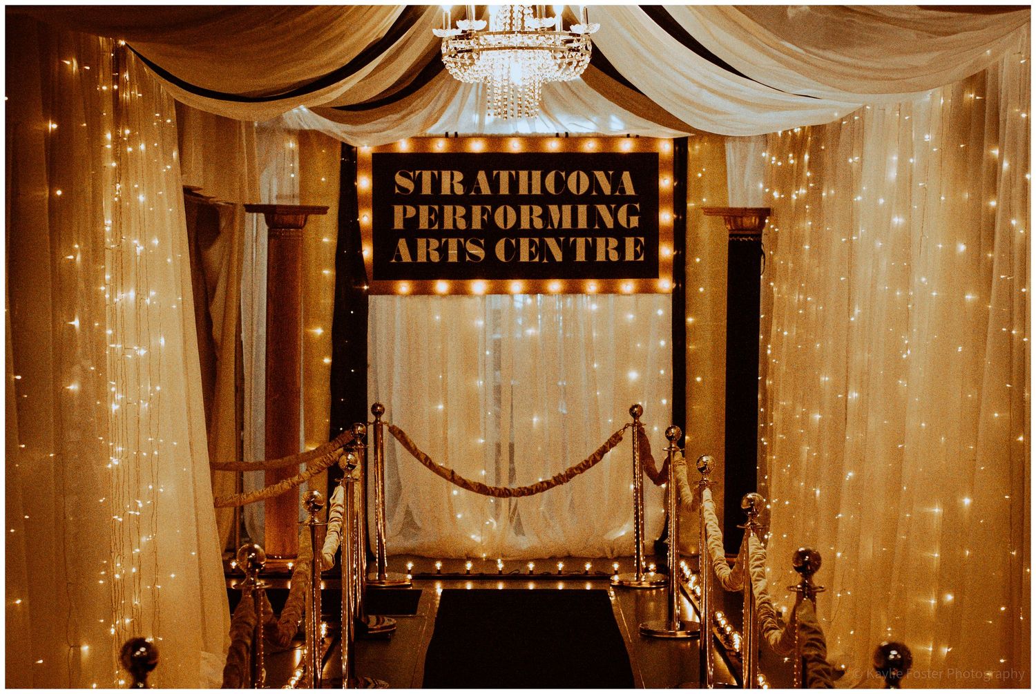 Elegant entrance to Strathcona Performing Arts Centre with marquee sign and twinkling fairy lights.