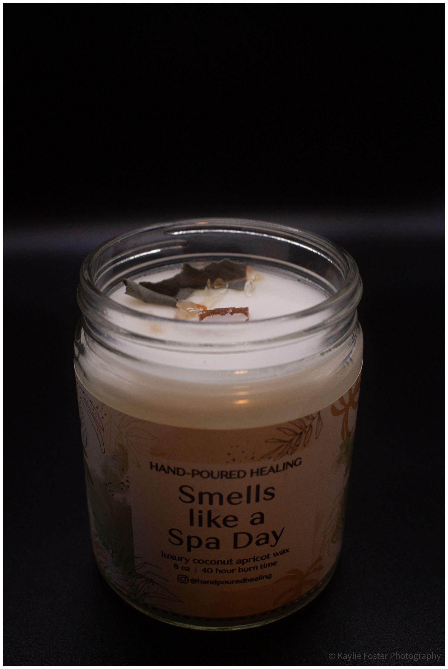 Hand-Poured Healing spa day scented soy candle in a clear glass jar with a wooden wick.