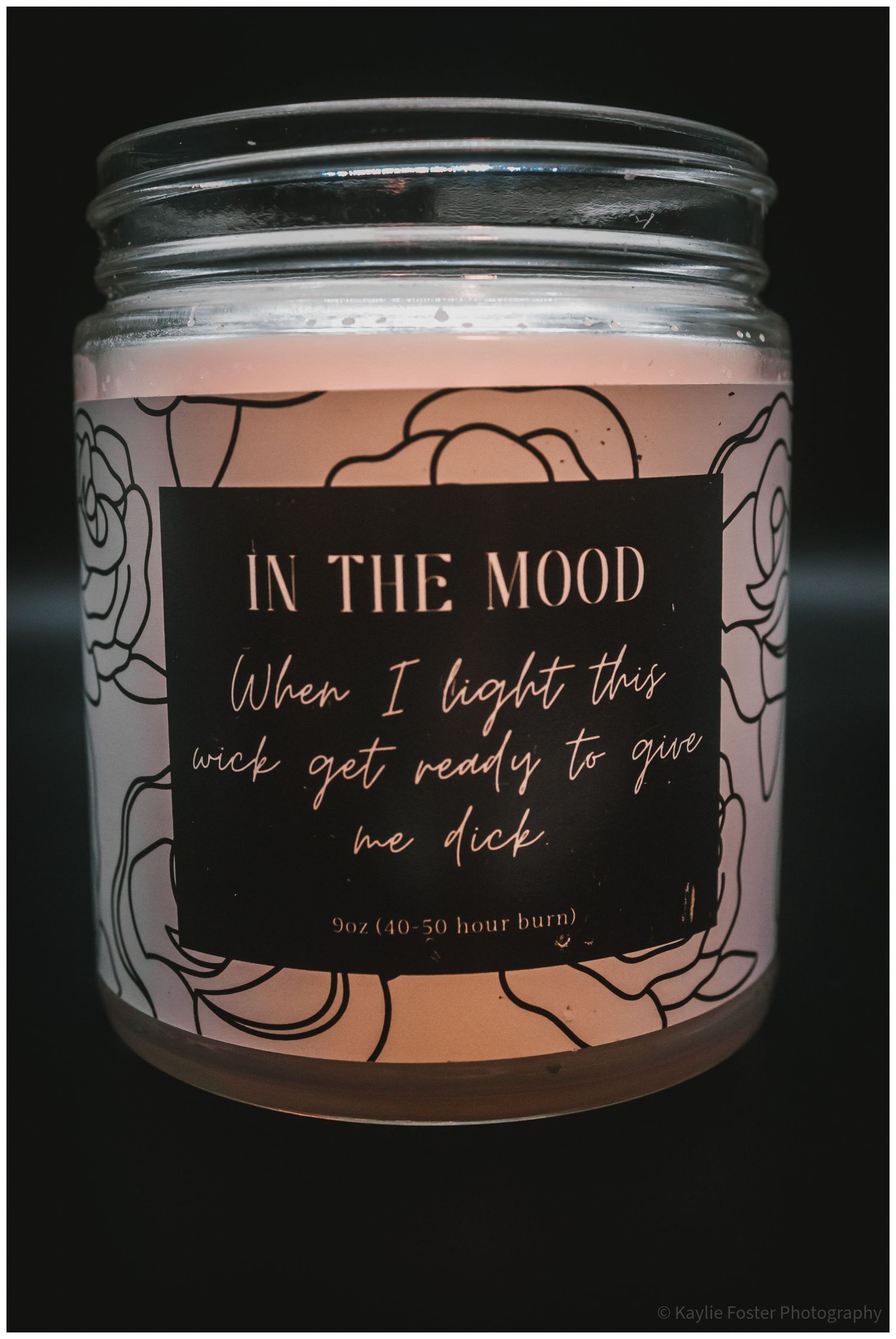 In The Mood 9oz soy candle in a glass jar with a floral label and humorous romantic message.
