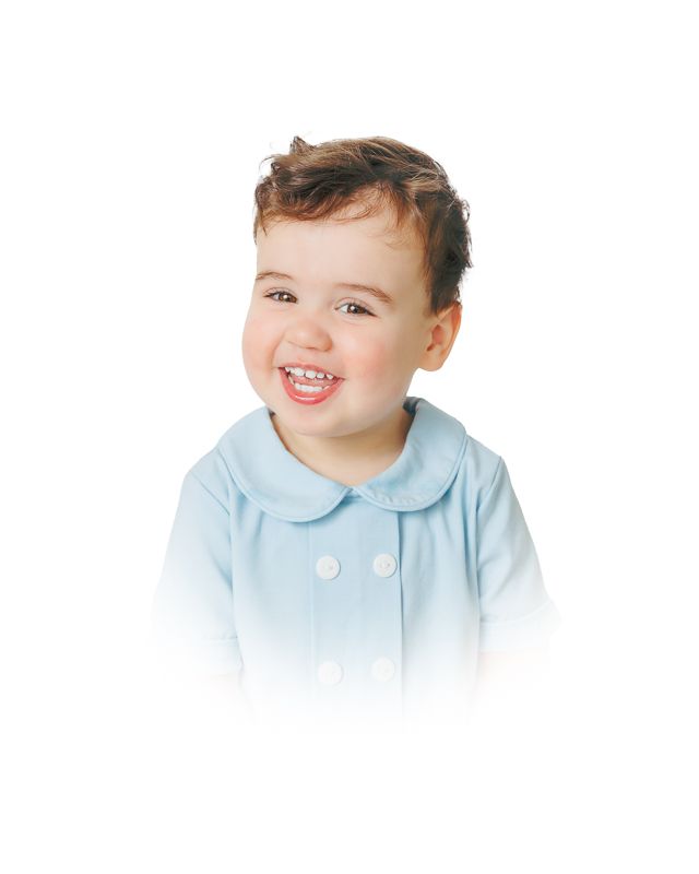 Smiling toddler wearing a light blue peter pan collar button-up top against a white background.