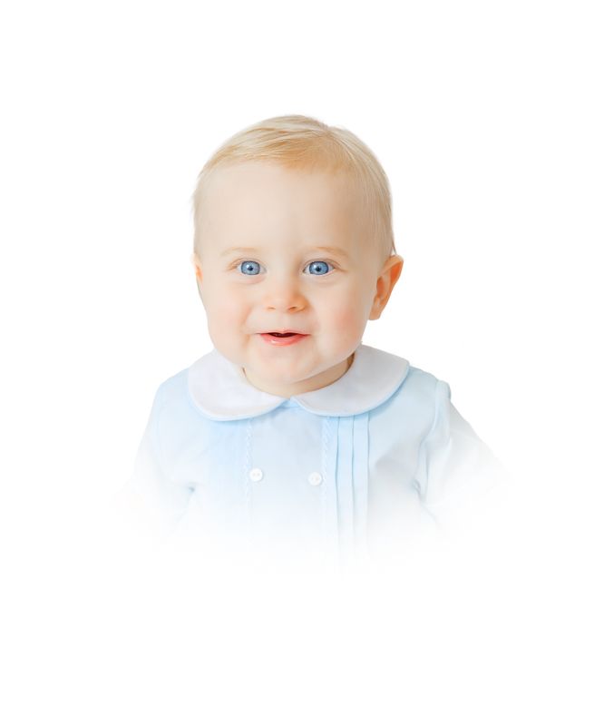 Smiling baby with blue eyes wearing a light blue collared outfit on a white background.