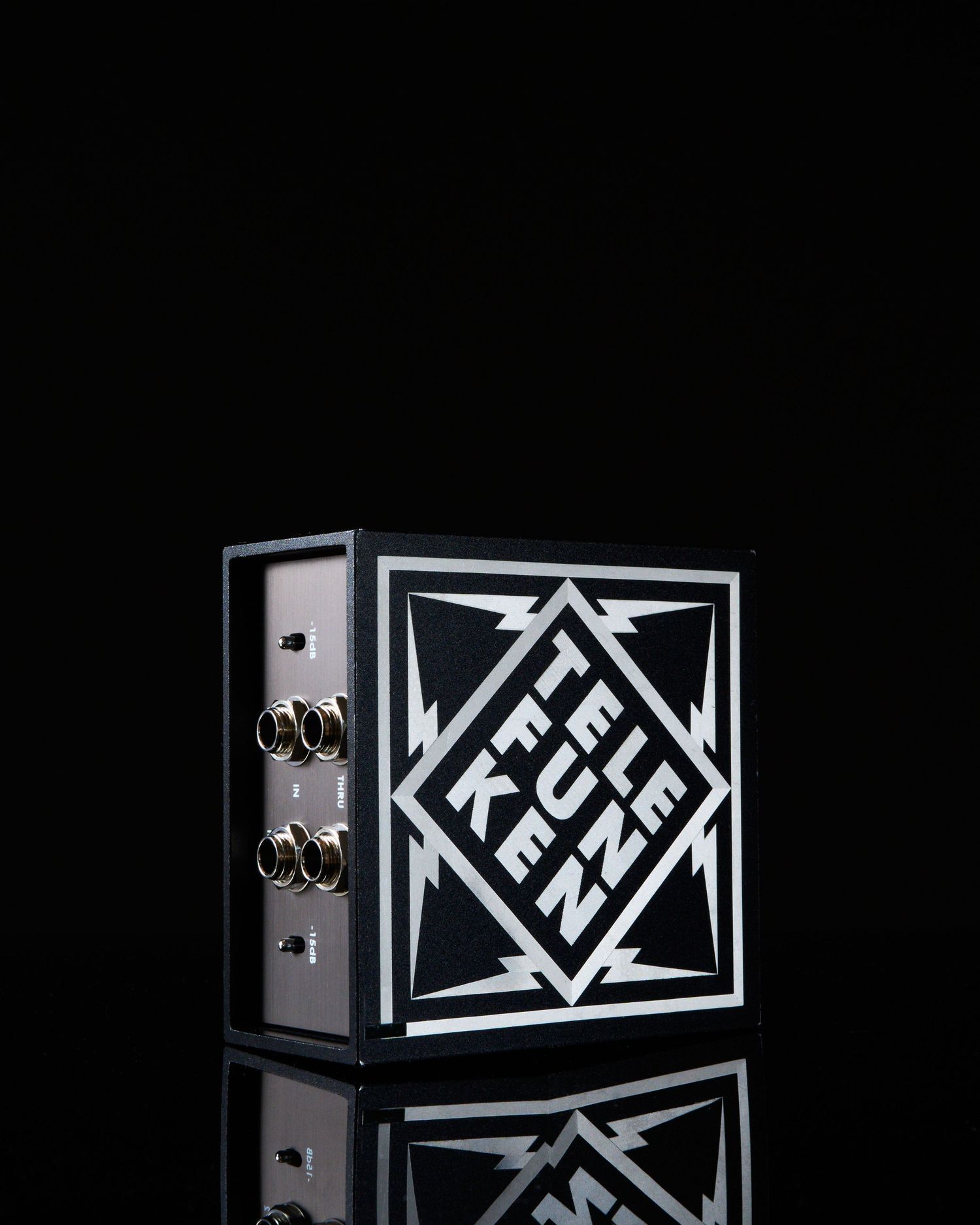 Black Telefunken audio device box with bold geometric logo design and BNC connectors on dark background.