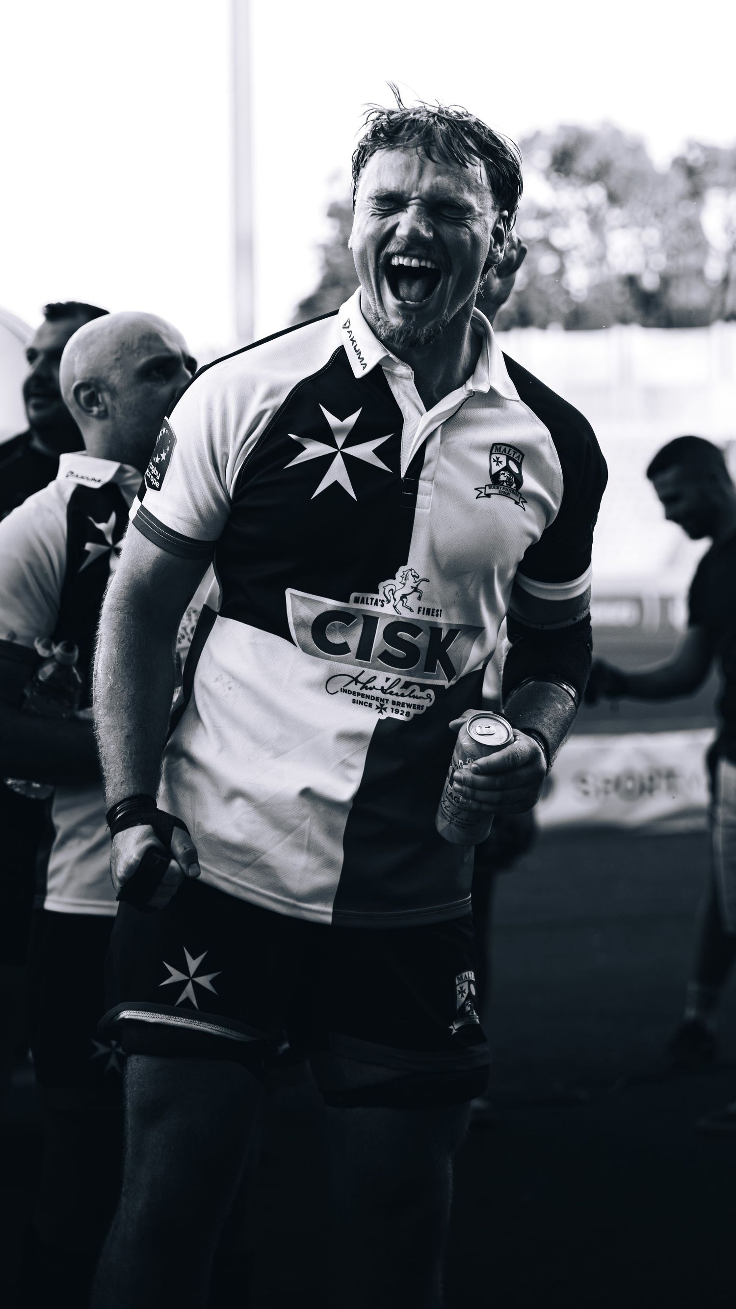 Black and white photo of an emotional rugby player celebrating intensely after a match.