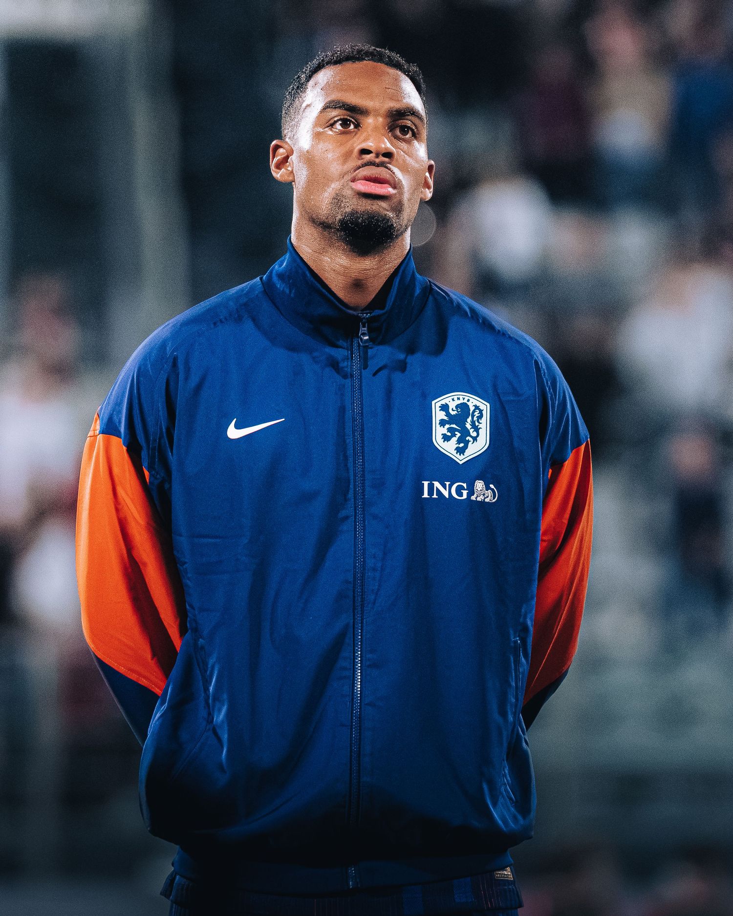 Ryan Gravenberch, football player wearing Dutch national team blue and orange Nike jacket with ING sponsor badge.