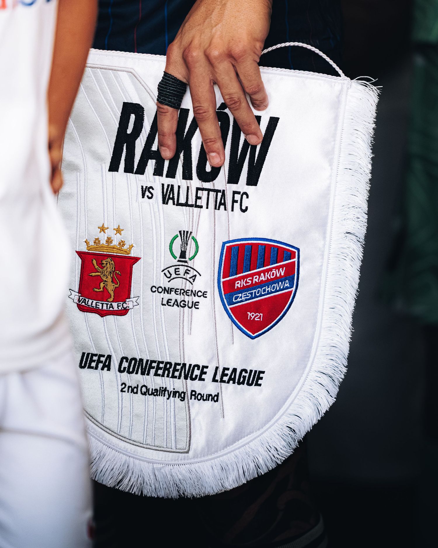 UEFA Conference League 2nd Qualifying Round pennant featuring Rakow vs Valletta FC club badges.