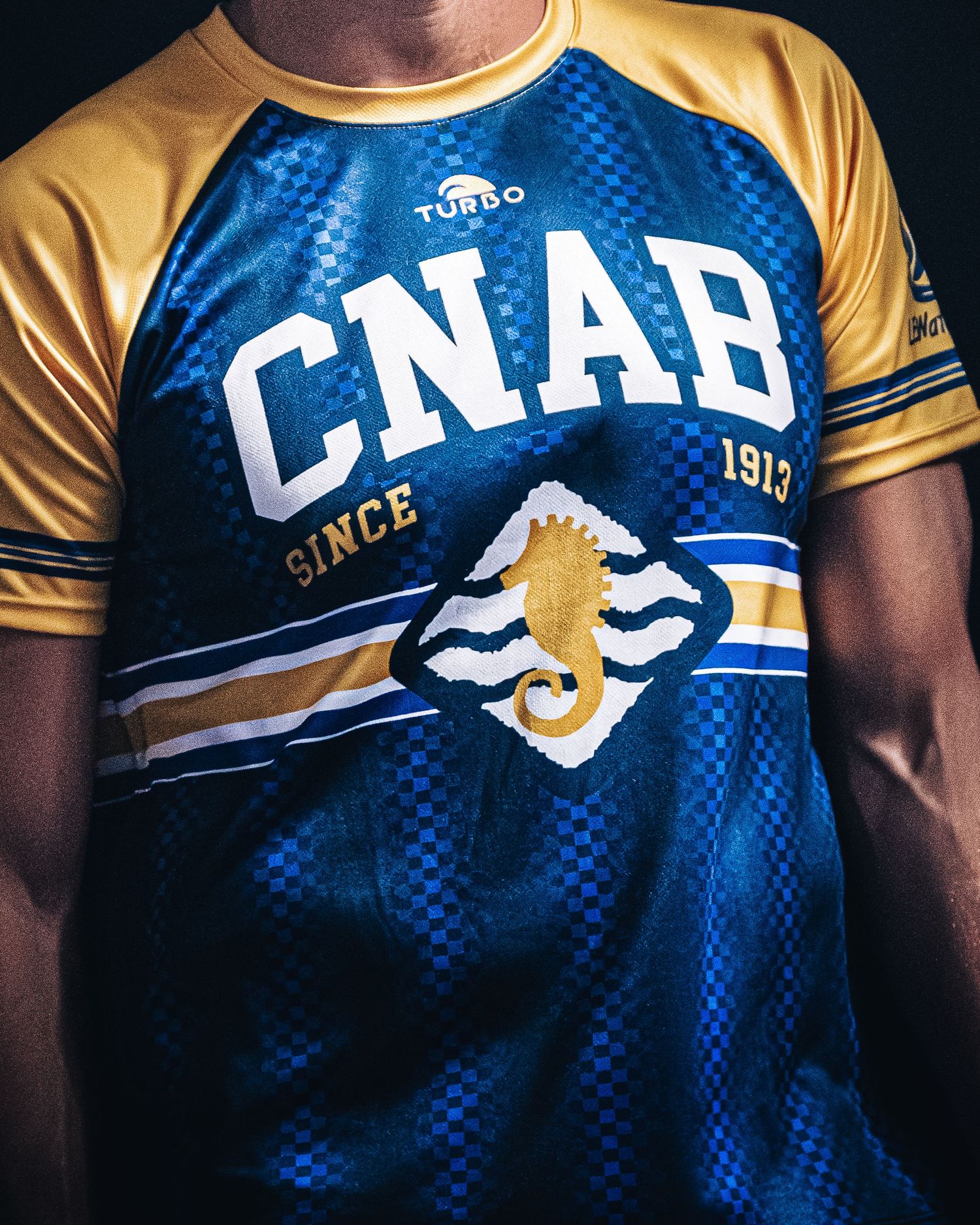 CNAB Since 1913 blue and gold water polo jersey by Turbo sportswear.