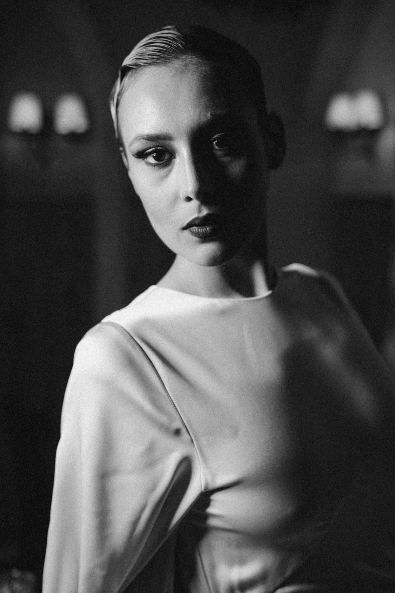 Striking black and white portrait of Nika Barišić with classic lighting and white high-neck dress. Actor, famous