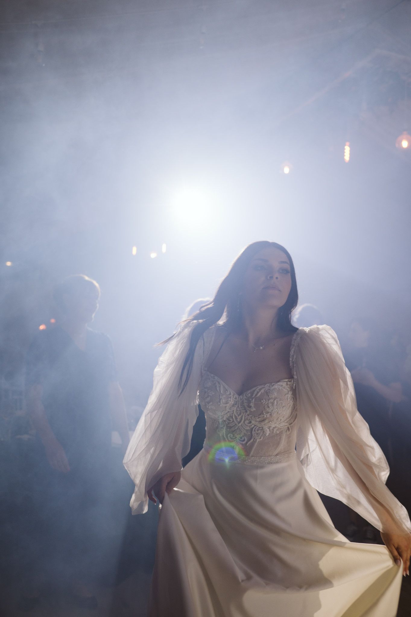 Ethereal dance scene with flowing white dress in atmospheric lighting.