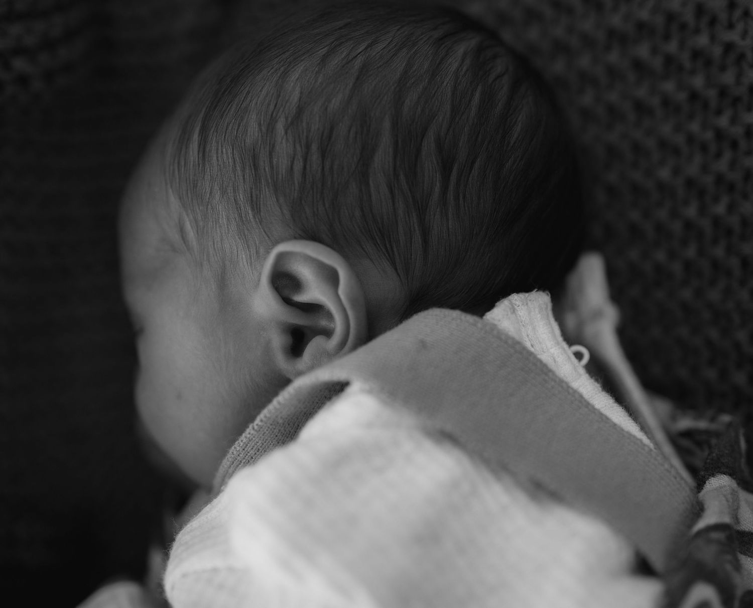 black and white photo of newborn baby close up of ear details