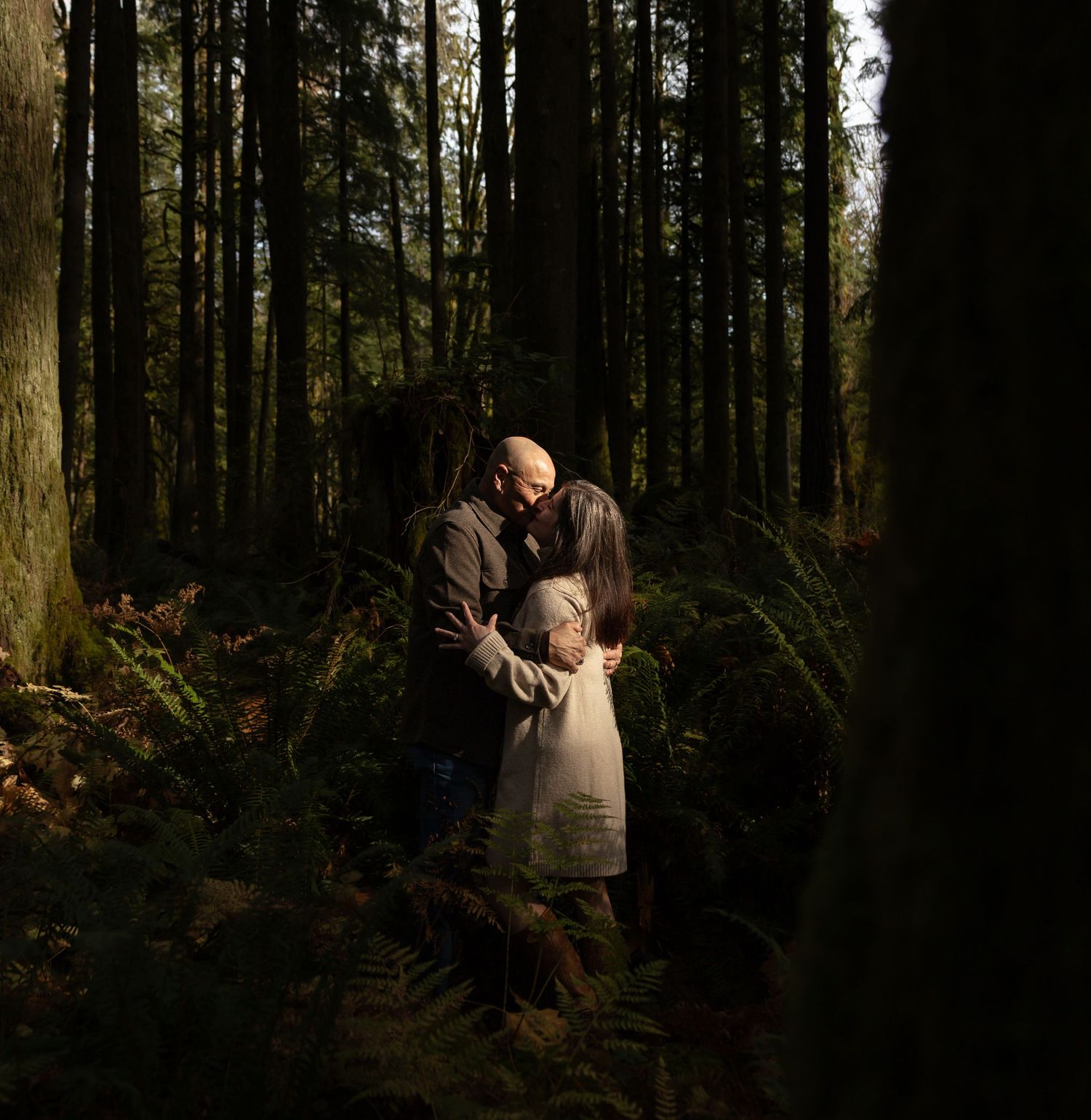 Romantic couples photography session in a forest setting, capturing genuine connection and candid moments in British Columbia.