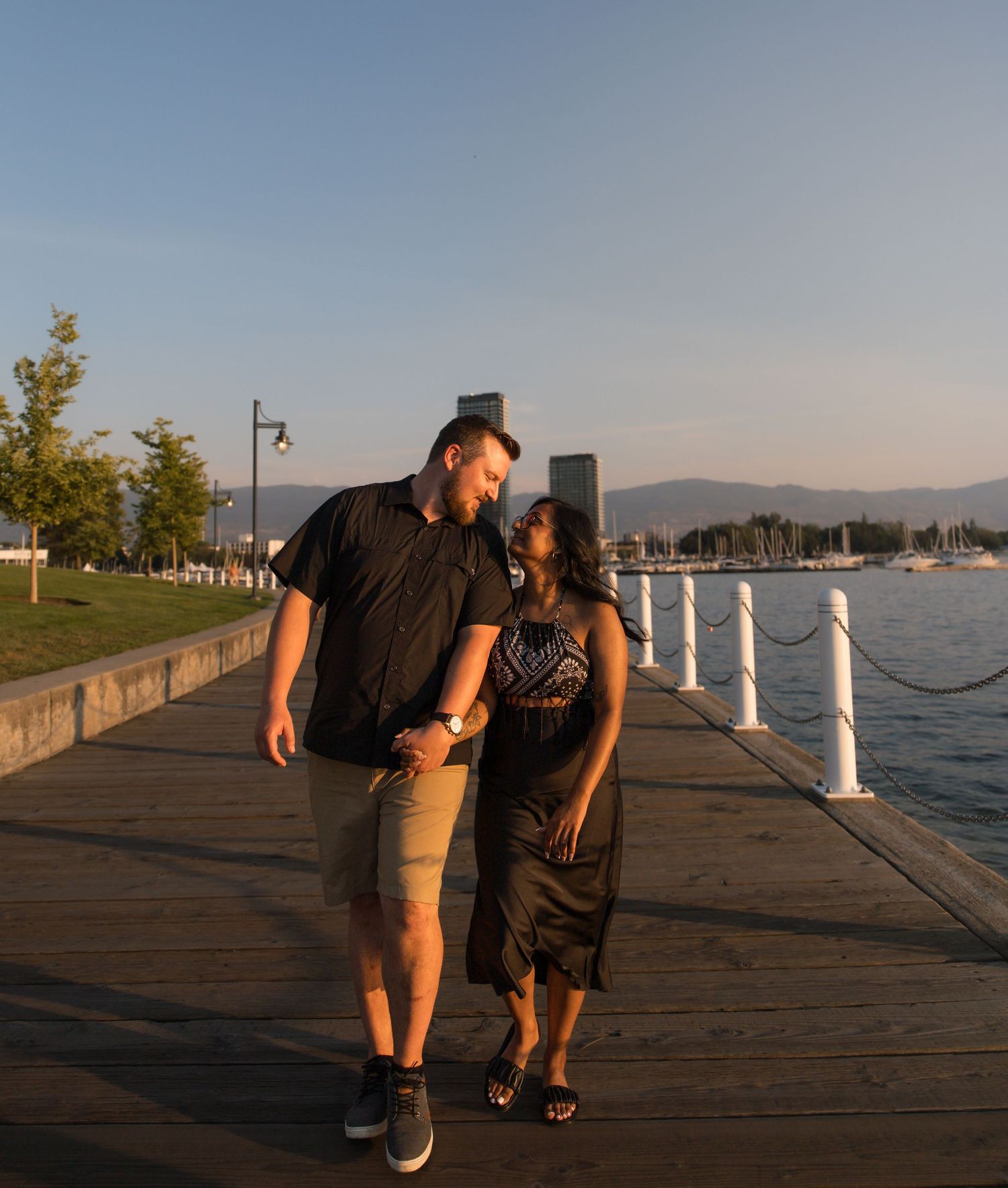 Romantic couples photography session on a waterfront pier at sunset in British Columbia, captured by Sheila's Photography.