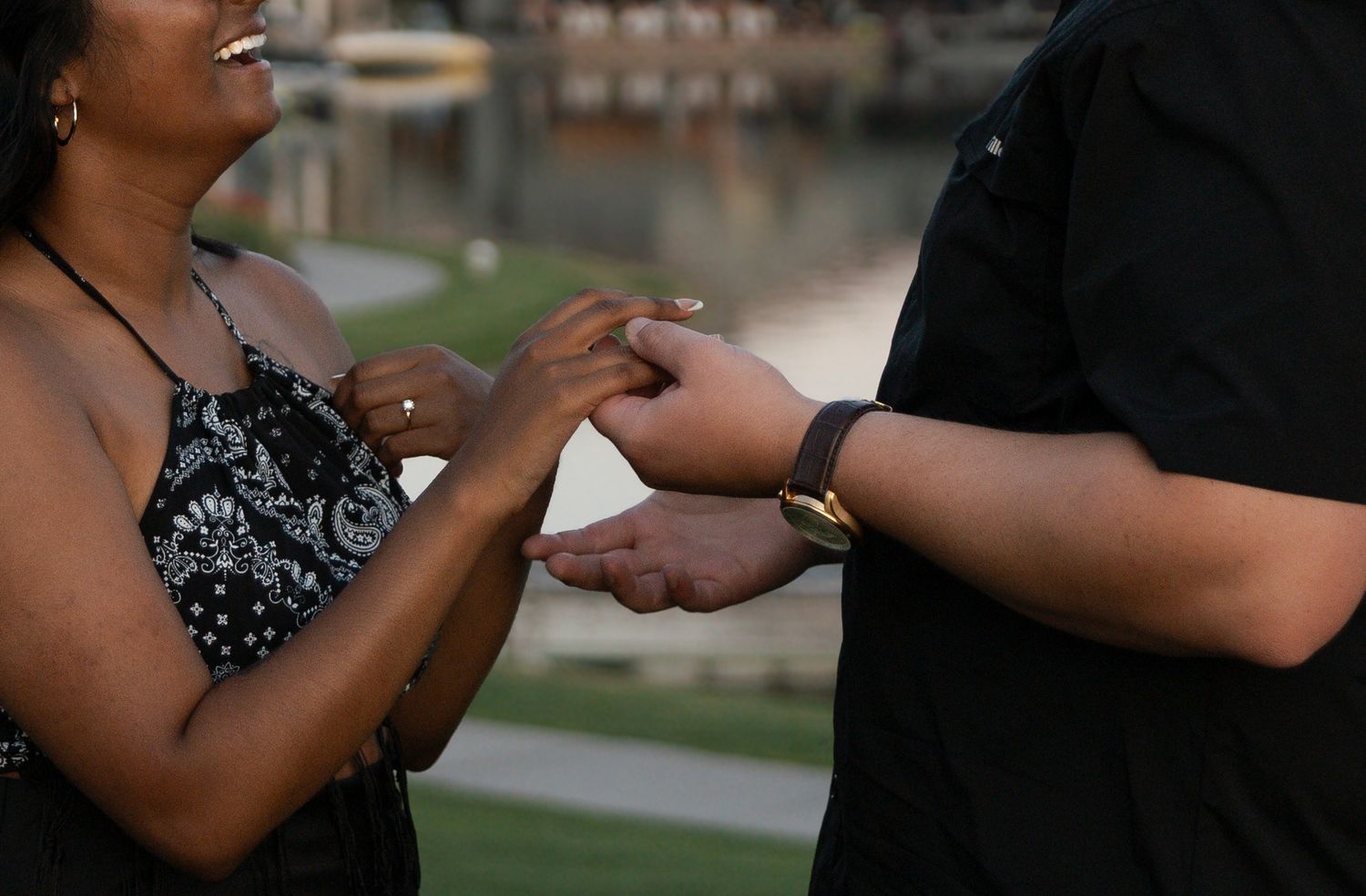 Close-up proposal photography capturing a couple holding hands shortly after a surprise engagement in Kelowna, BC.