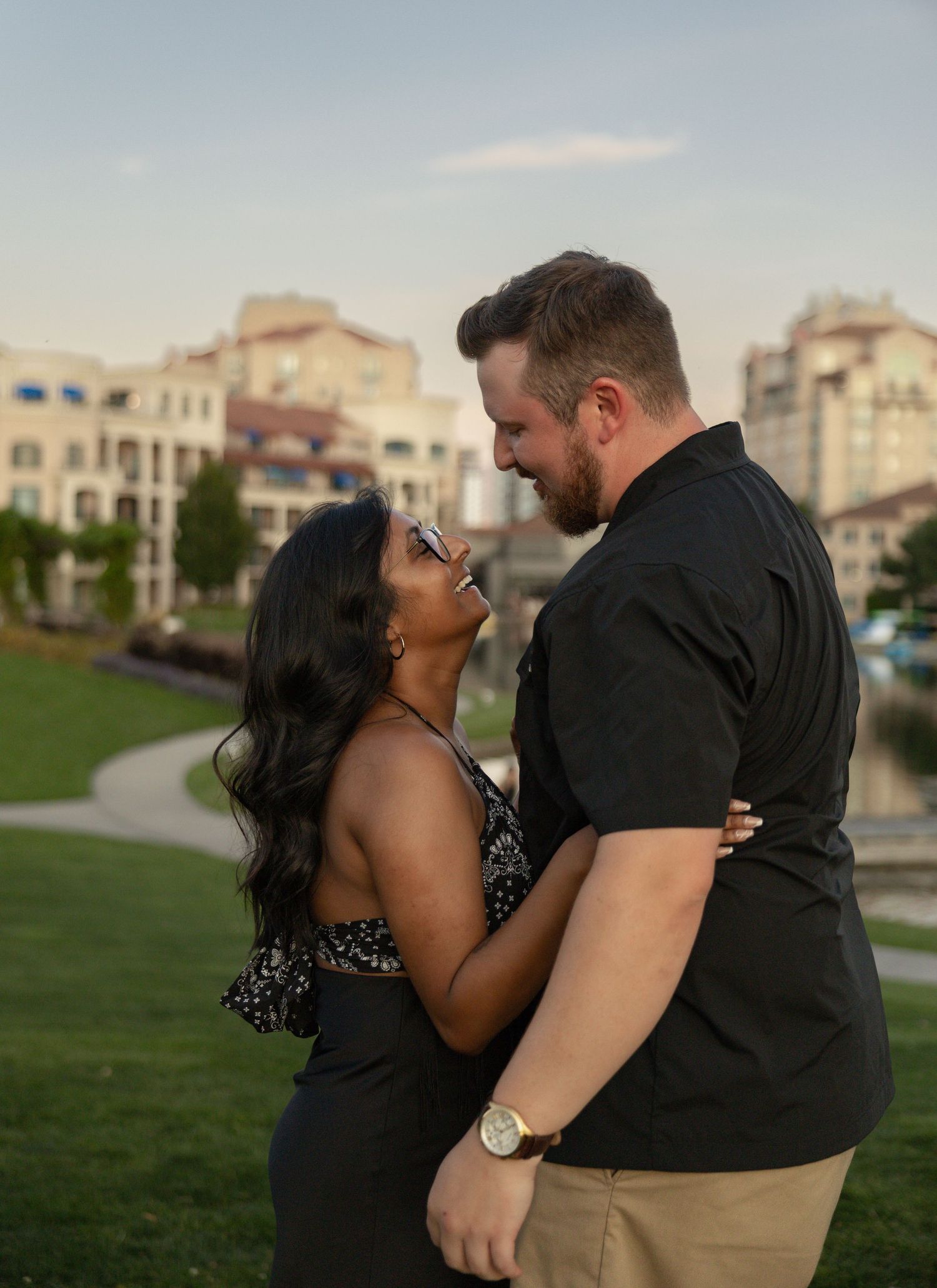 Newly engaged couple celebrating after a surprise proposal in Kelowna, British Columbia during a romantic engagement session.