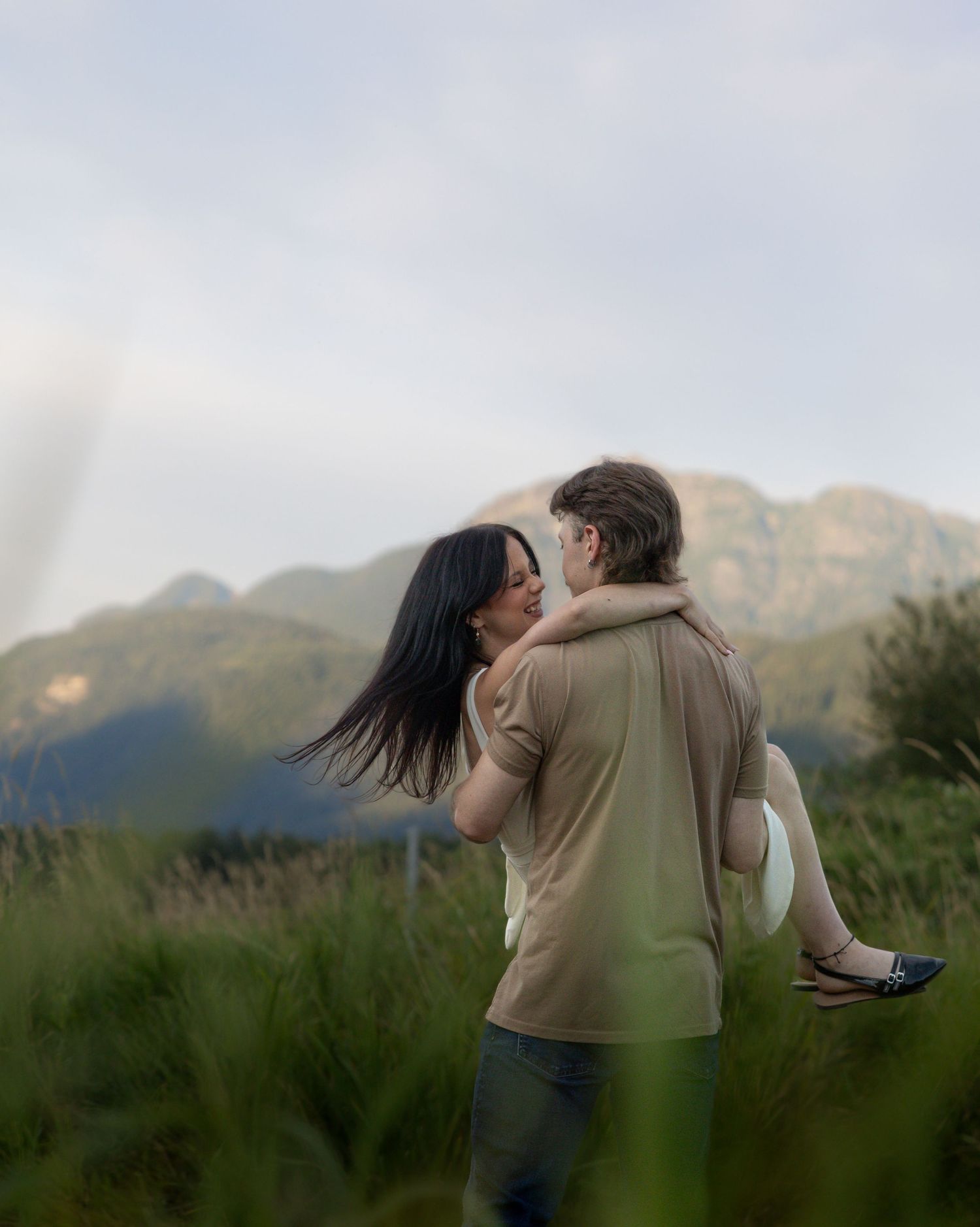 Mountain engagement session in British Columbia featuring a couple embracing at sunset, photographed by a BC engagement photographer.