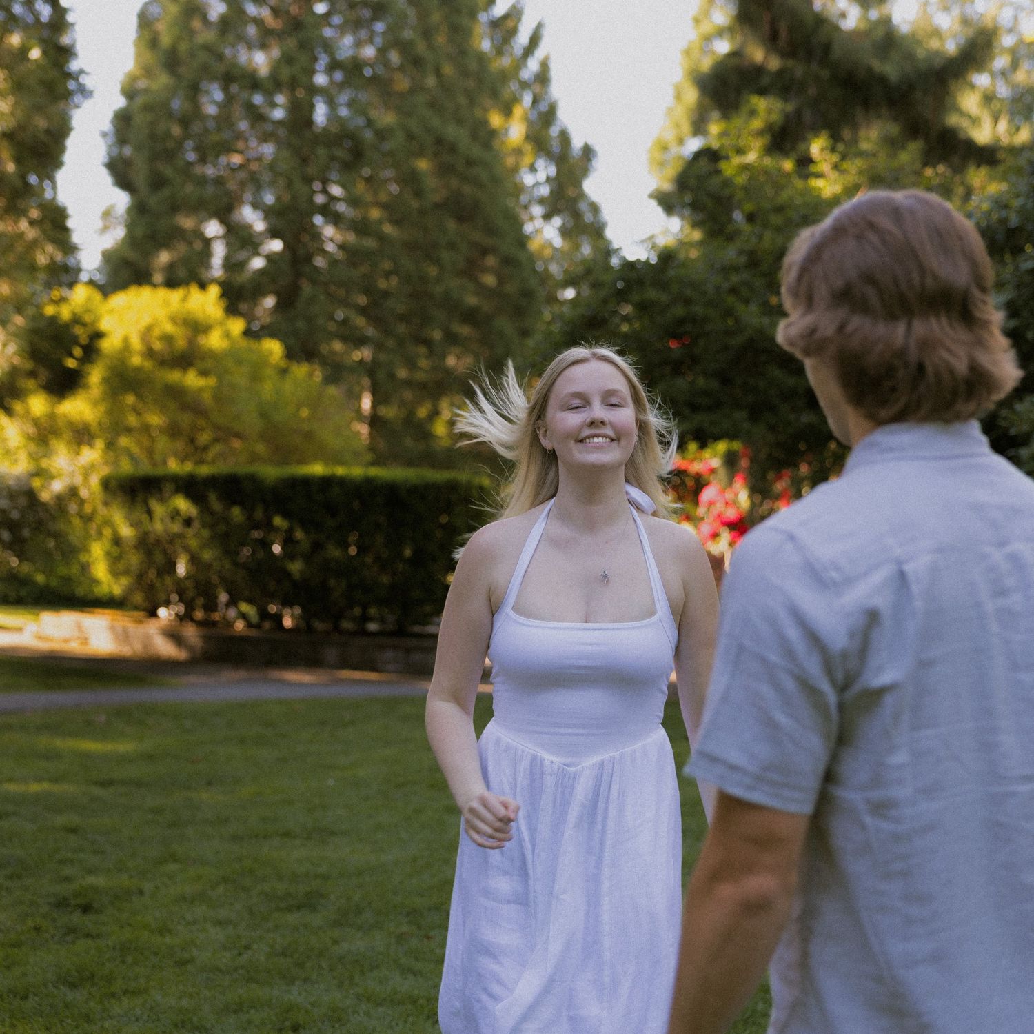 Romantic engagement session in a lush park, captured by a Lower Mainland BC engagement photographer.