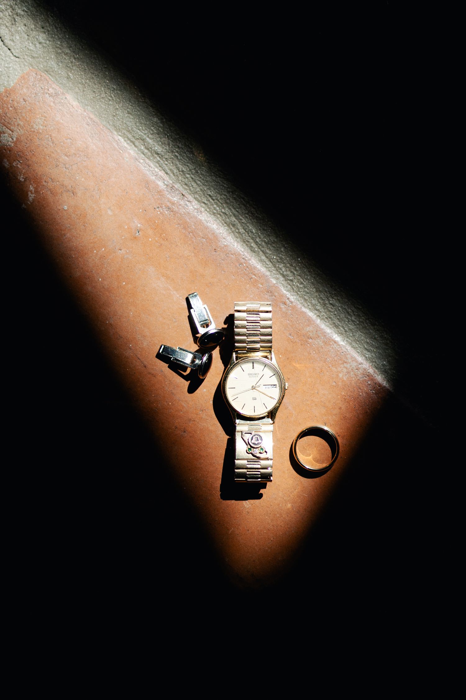 A sequence showing a watch falling and breaking apart against a dark background with dramatic lighting.