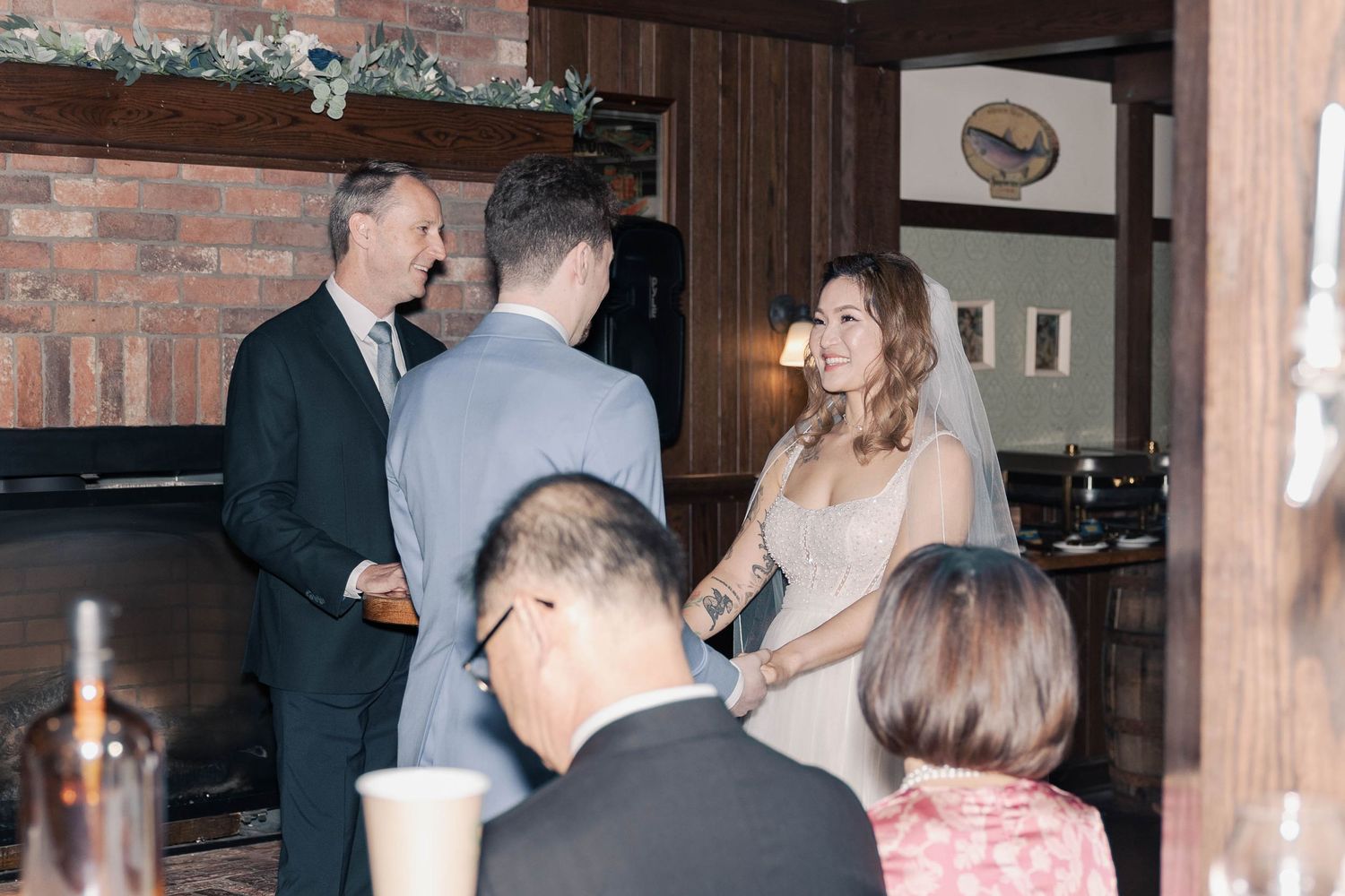 Reception venue interior with brick walls and wooden pillars.