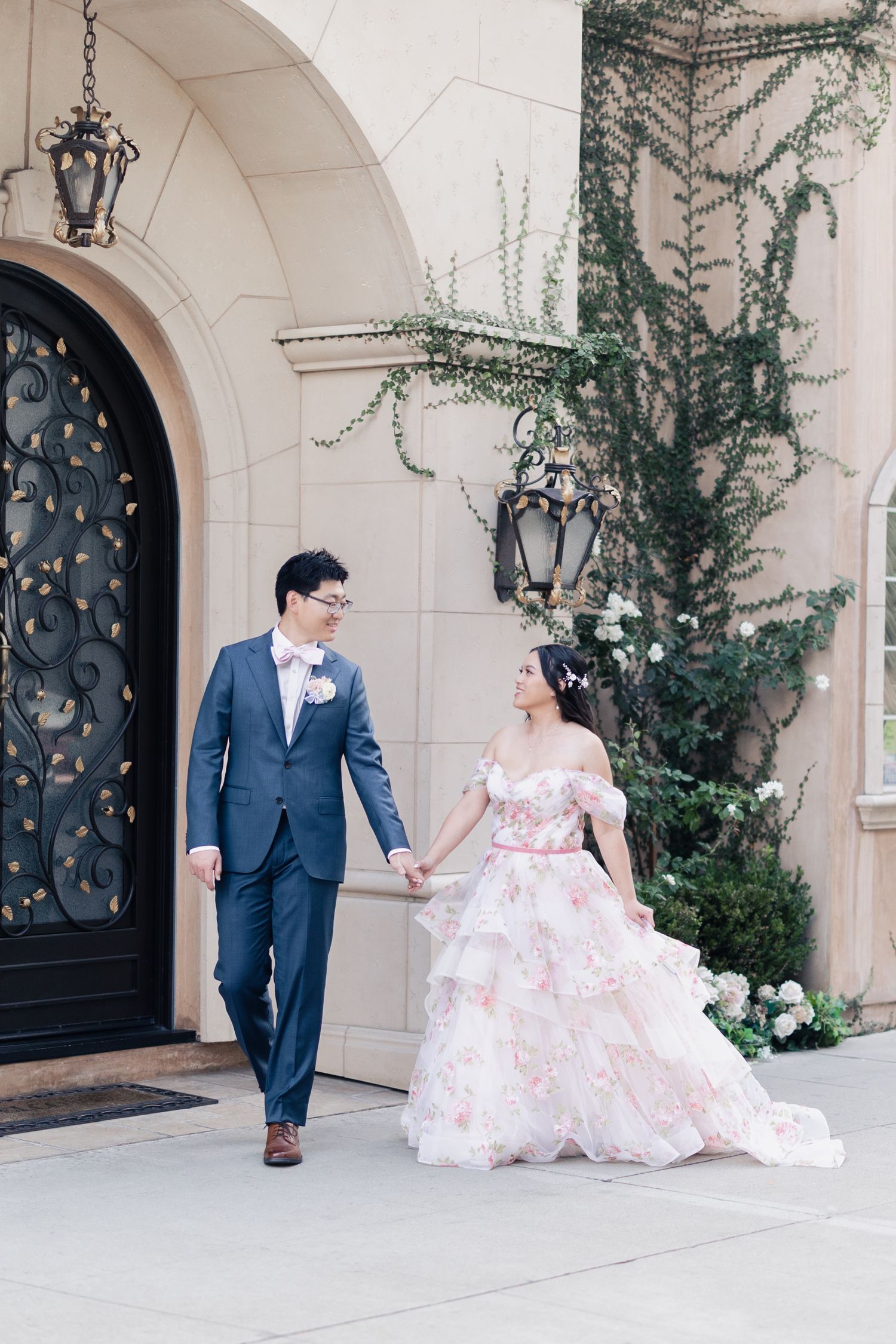 A couple in wedding attire shares playful moments in a series of photos along an elegant arched walkway.