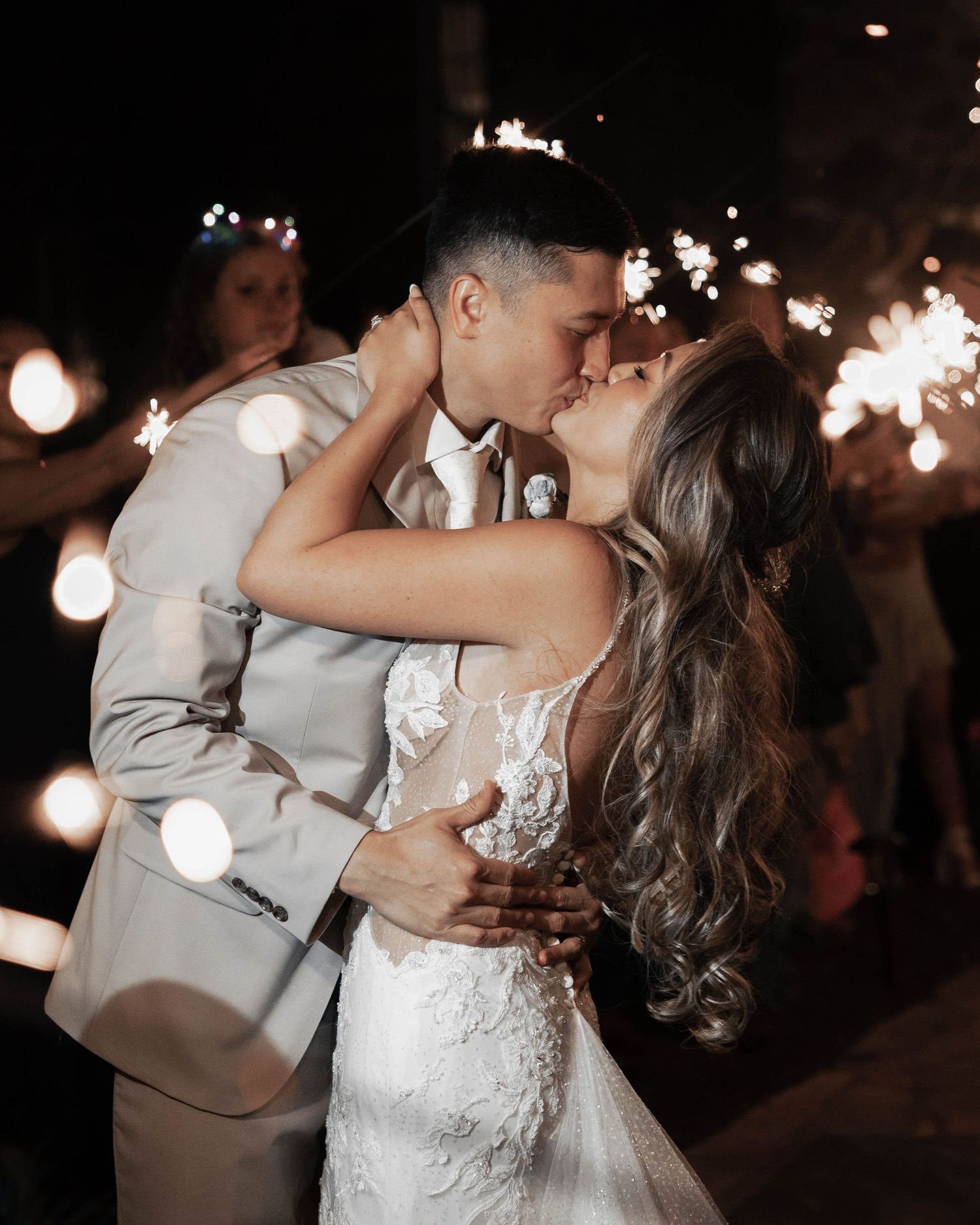 Romantic sparkler-lit dance between newlyweds during their wedding reception.