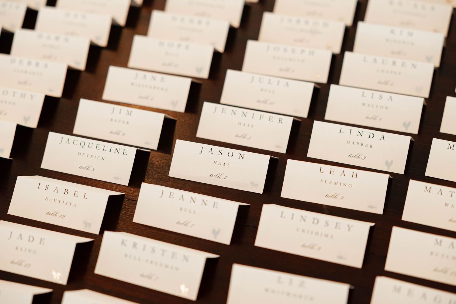 Rows of white name tags or labels arranged in a diagonal pattern on a dark background.