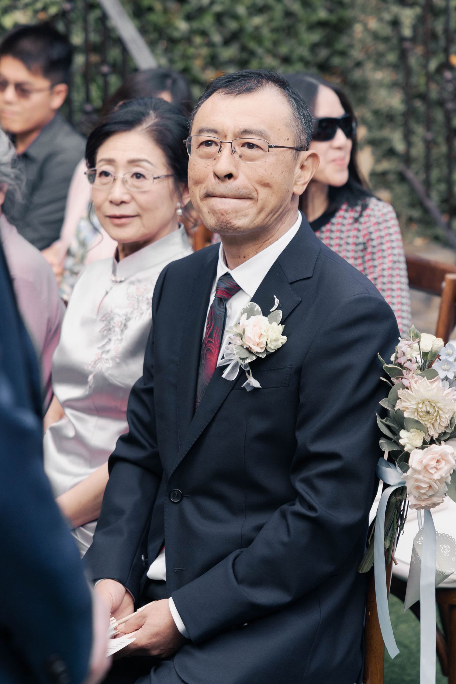 A series of candid moments captured at an outdoor wedding ceremony with guests seated in white chairs.
