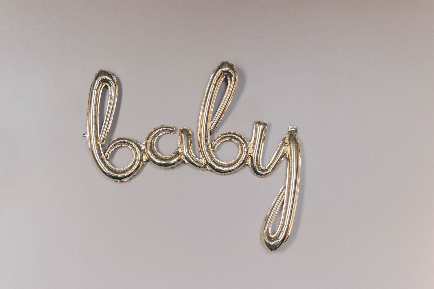 Metallic silver balloon letters spelling out 