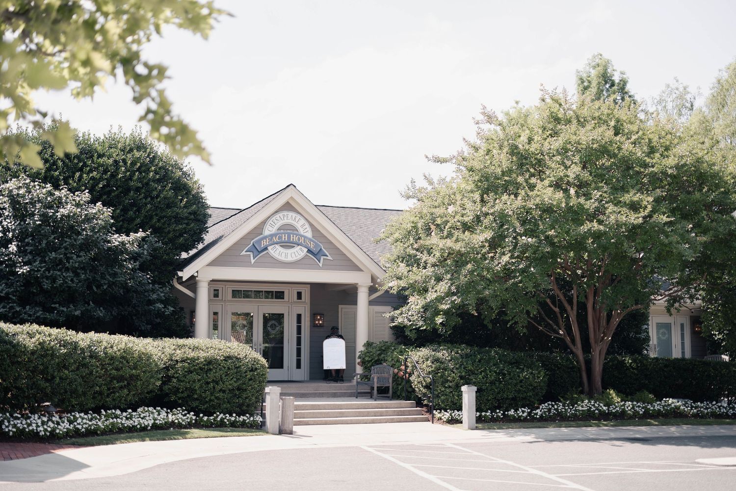 Exterior view of traditional style buildings with dormer windows and landscaped grounds.