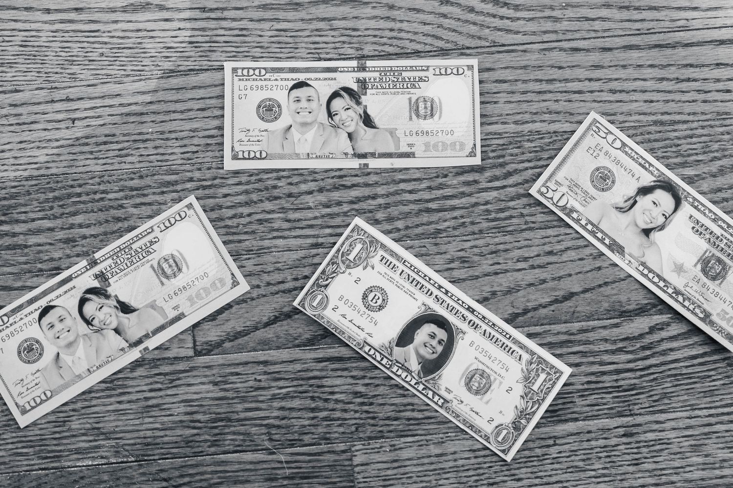 Dollar bills arranged artistically on dark wooden surface.