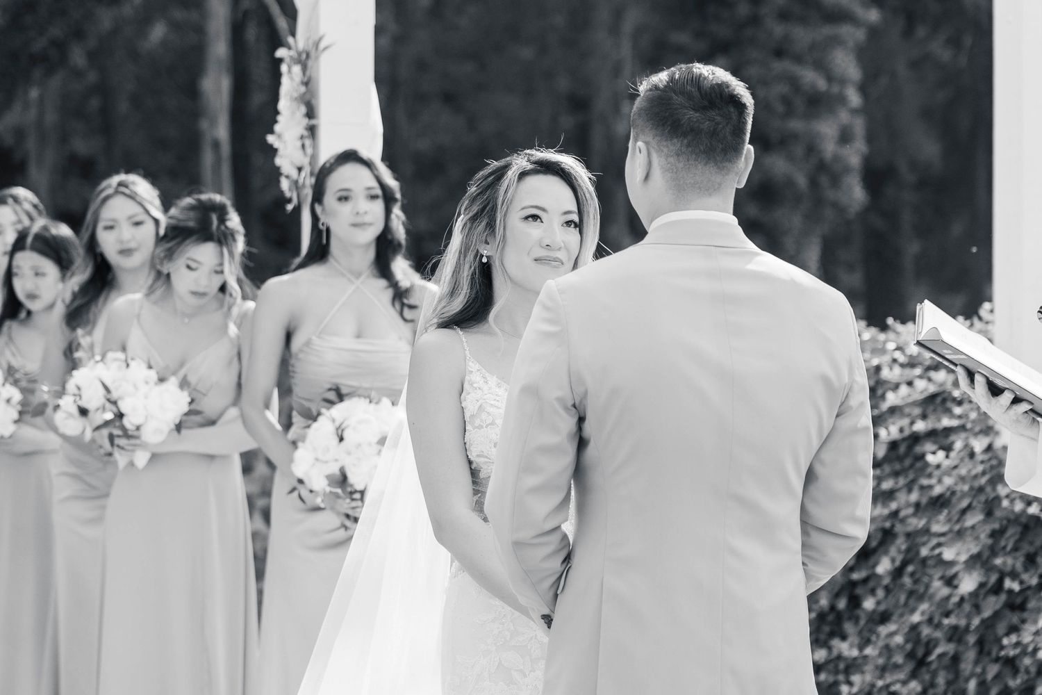 Guests smiling and celebrating during outdoor wedding reception.