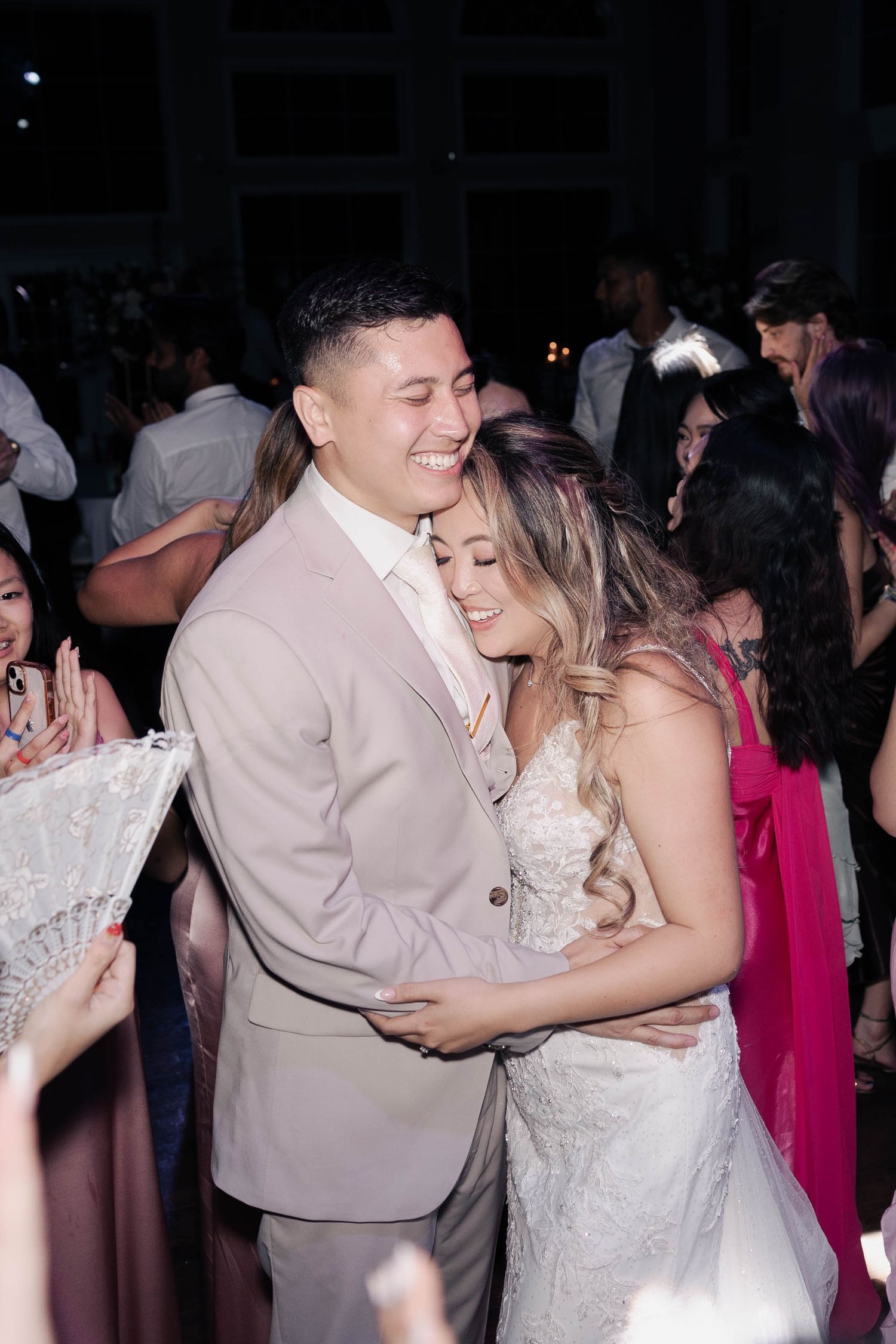 Newlyweds sharing tender moments during dance floor time at a wedding reception.