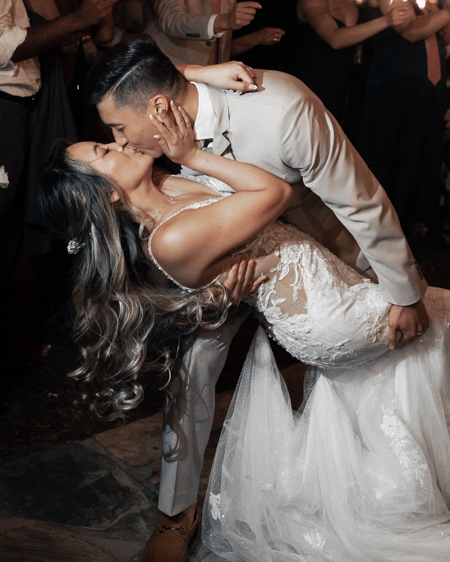 Dramatic wedding dance dip captured during the sparkler exit.