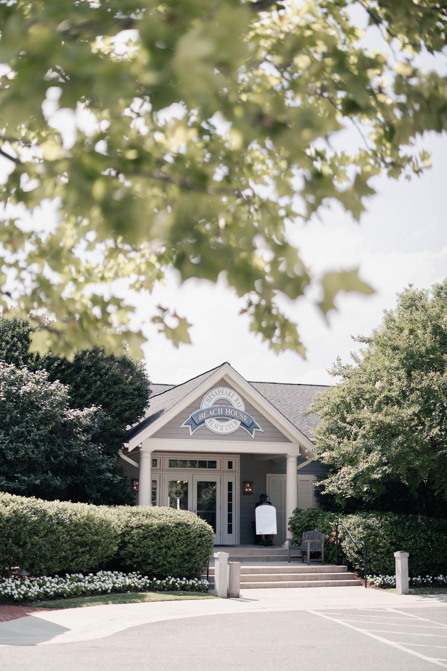 Elegant coastal venue exterior with white columns and landscaped gardens.