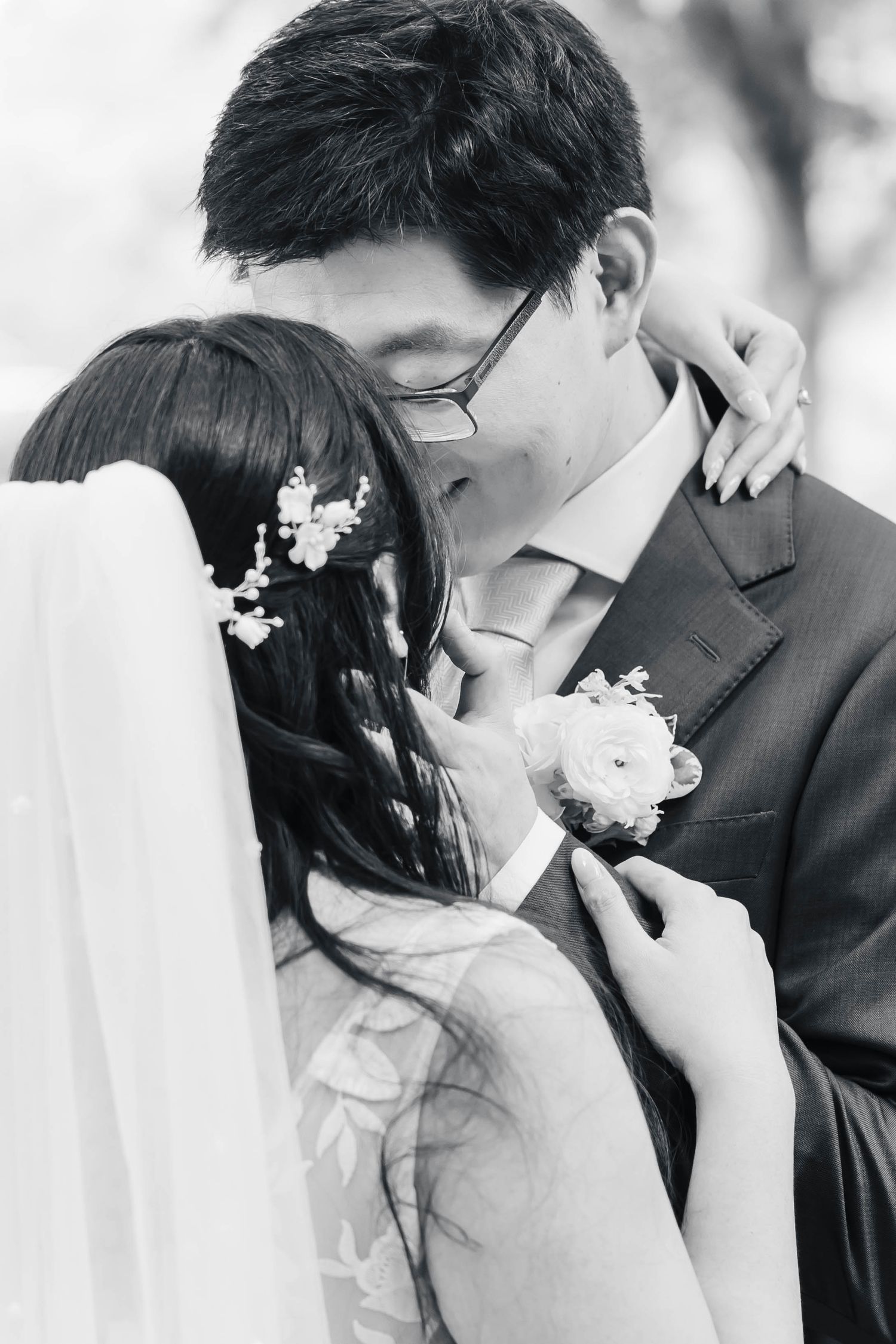 A romantic black and white photo series showing a couple in an intimate embrace sharing tender kisses.