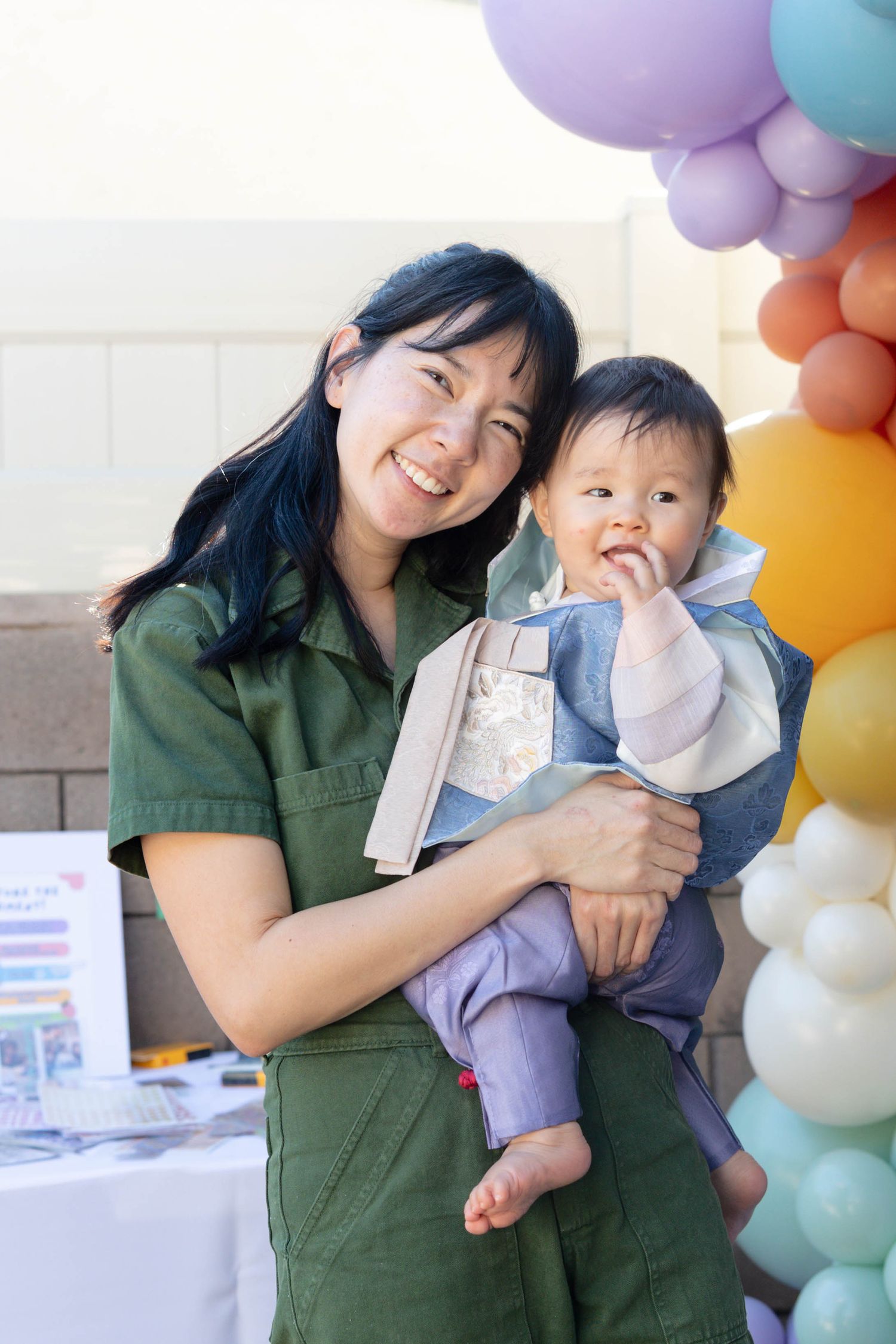 A series of five connected photos showing joyful moments between parent and child with colorful balloon decorations.