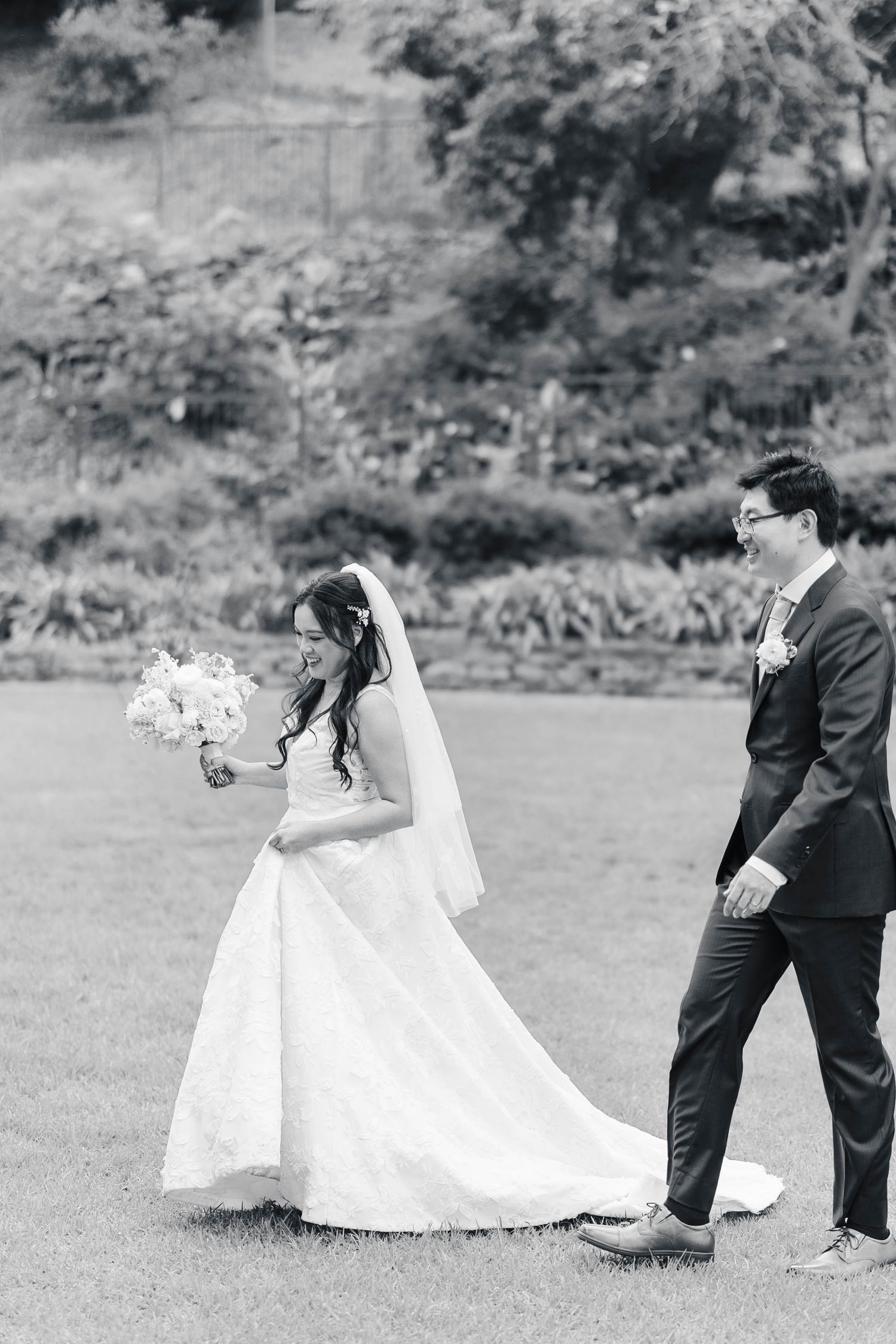 A playful wedding sequence shows the couple chasing each other across a grassy field in black and white.