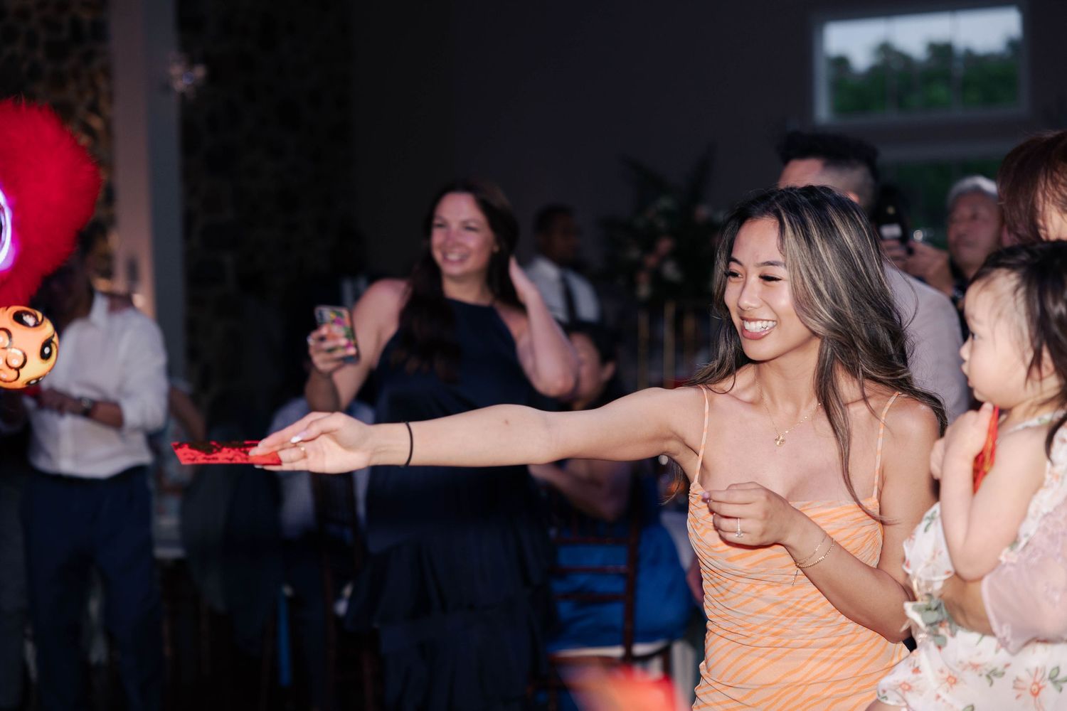 Wedding guests dancing and celebrating during reception party.
