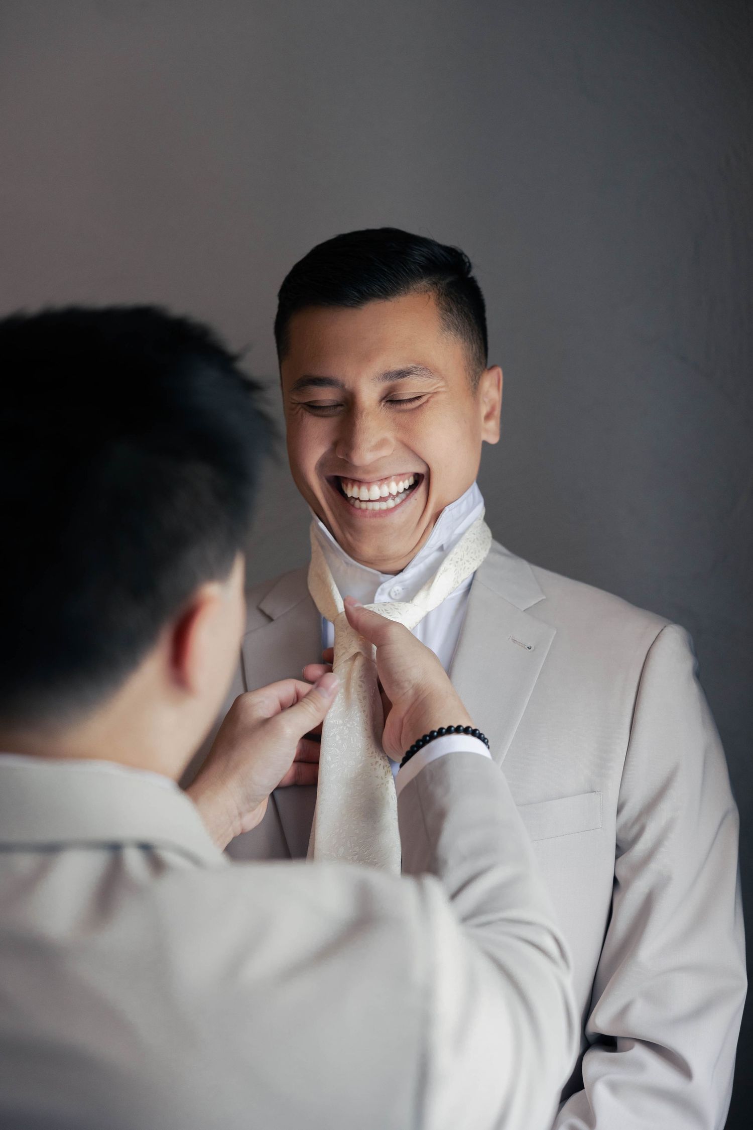 Candid moments of laughter and joy captured against a dark background.