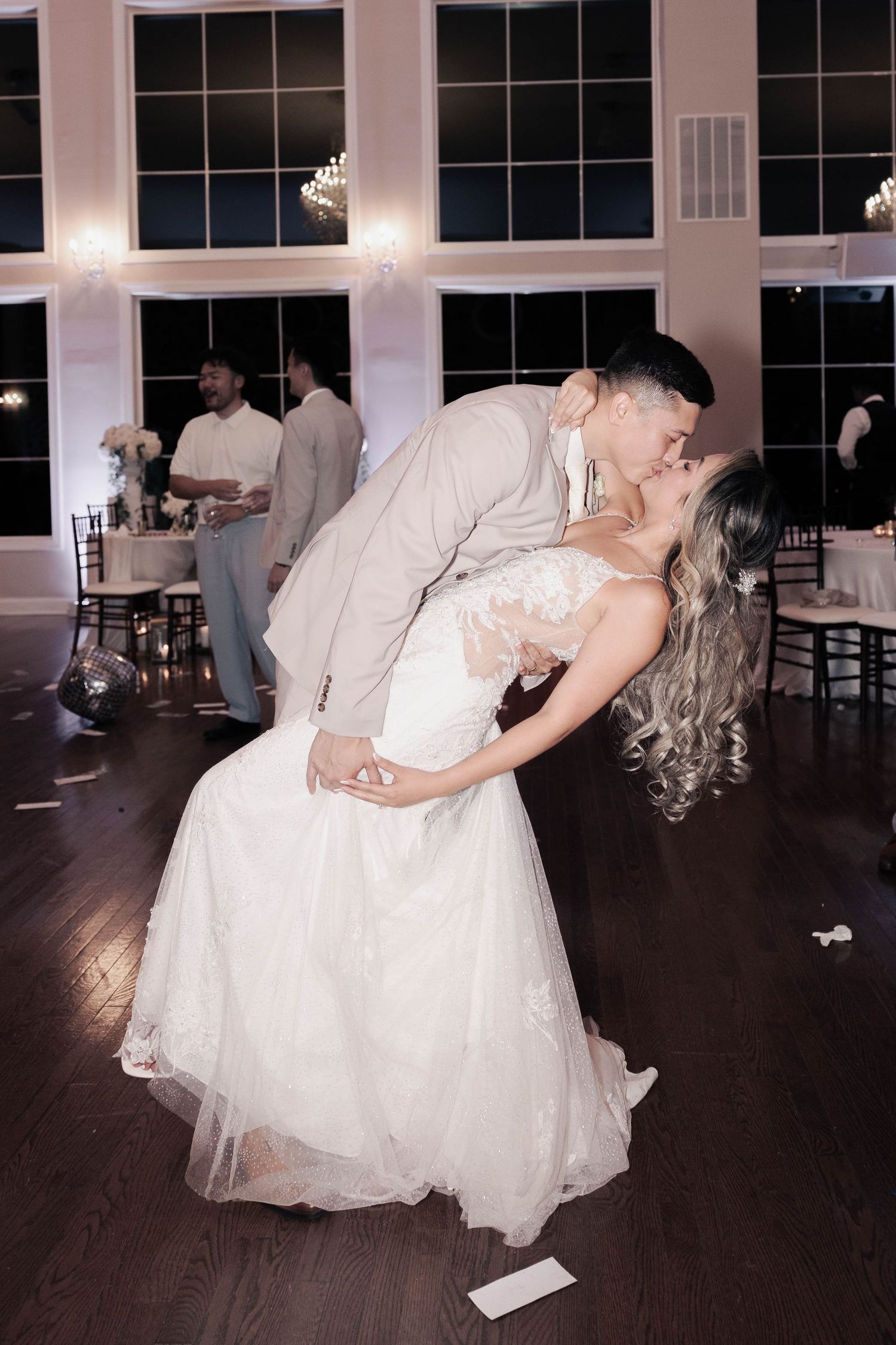 A romantic wedding dance sequence with a dramatic dip on a dark wooden floor.