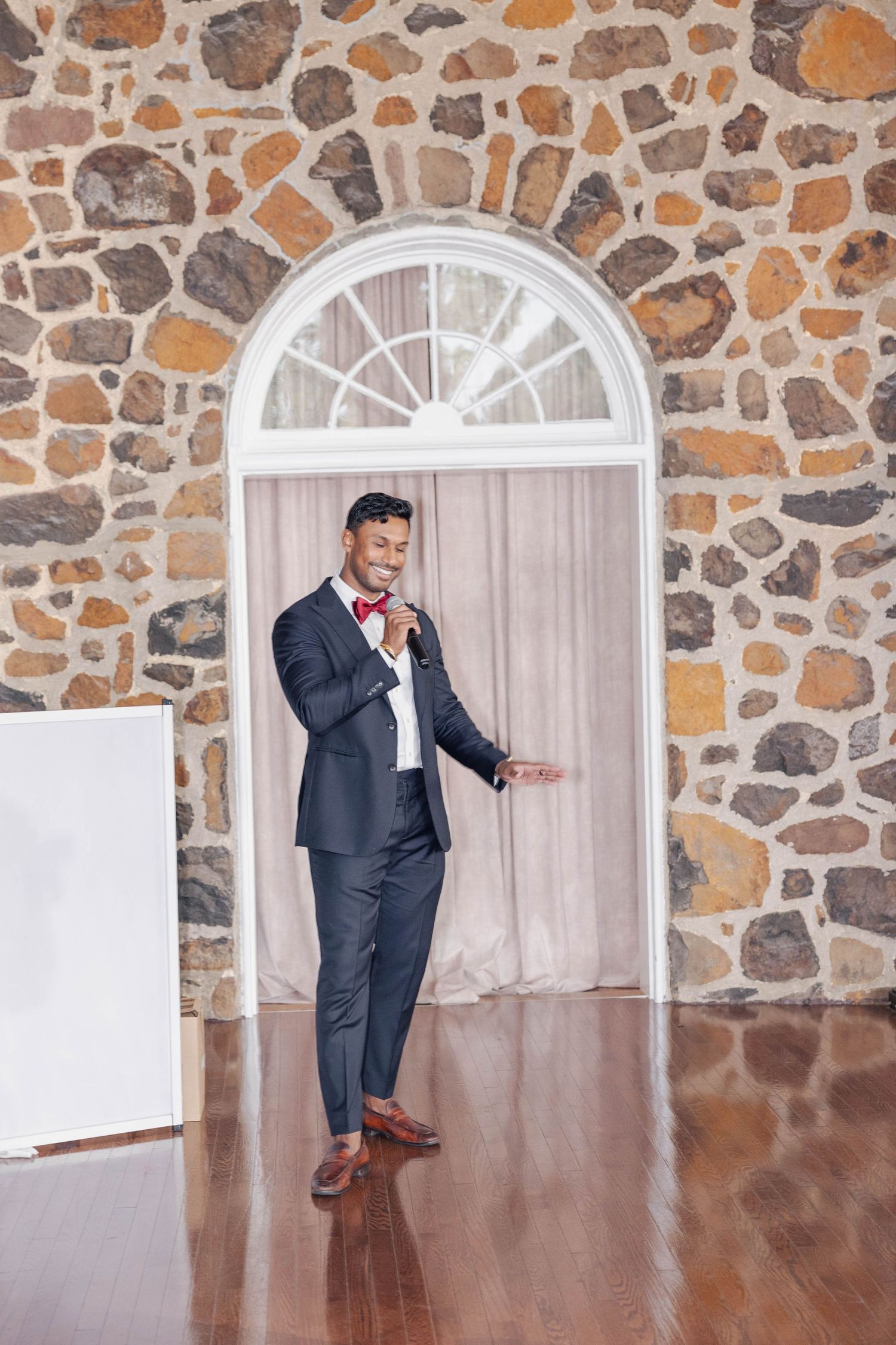 Dancing sequence in an elegant stone-walled venue with hardwood floors.