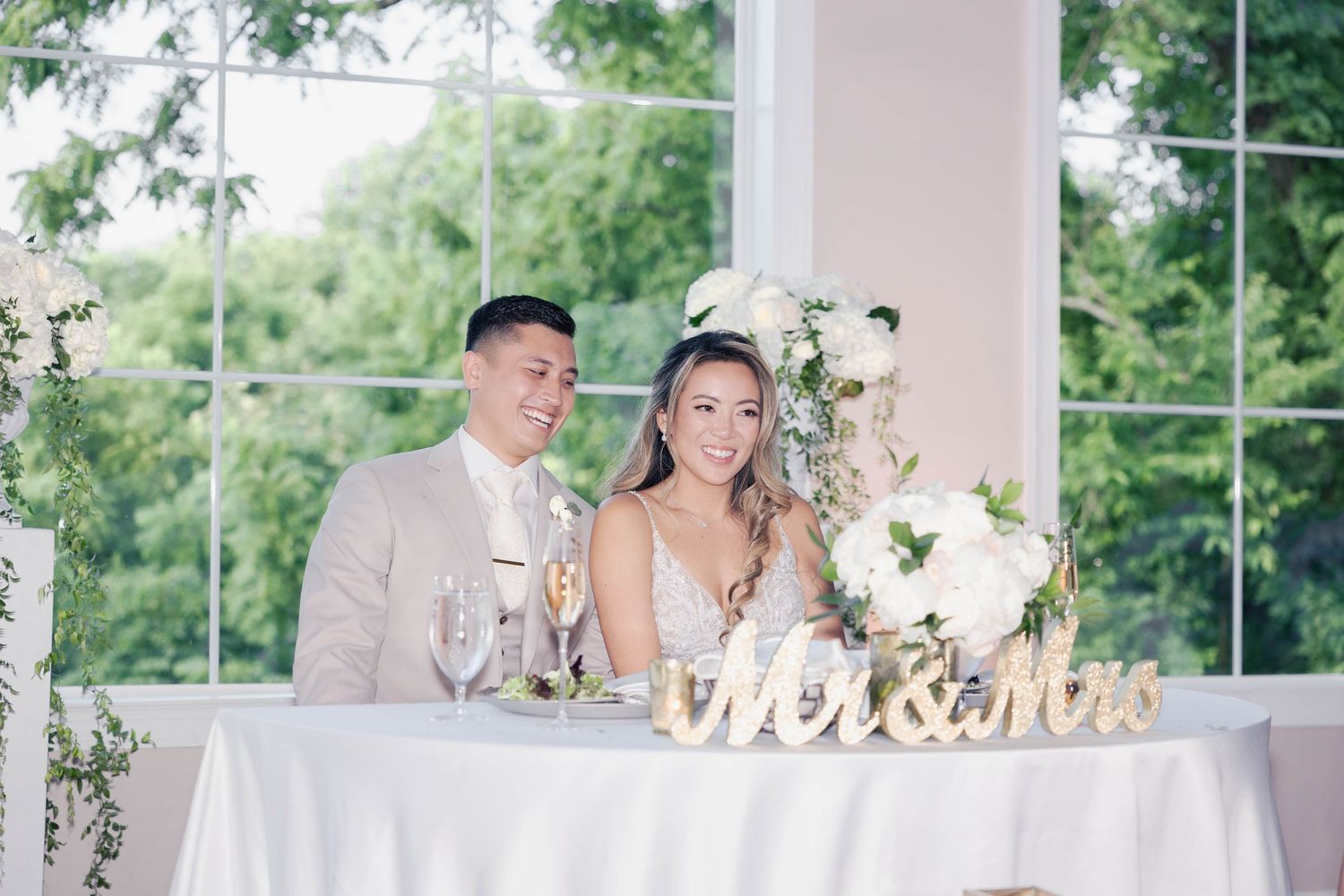 Elegant wedding reception table with 'Mr & Mrs' sign and floral decorations.